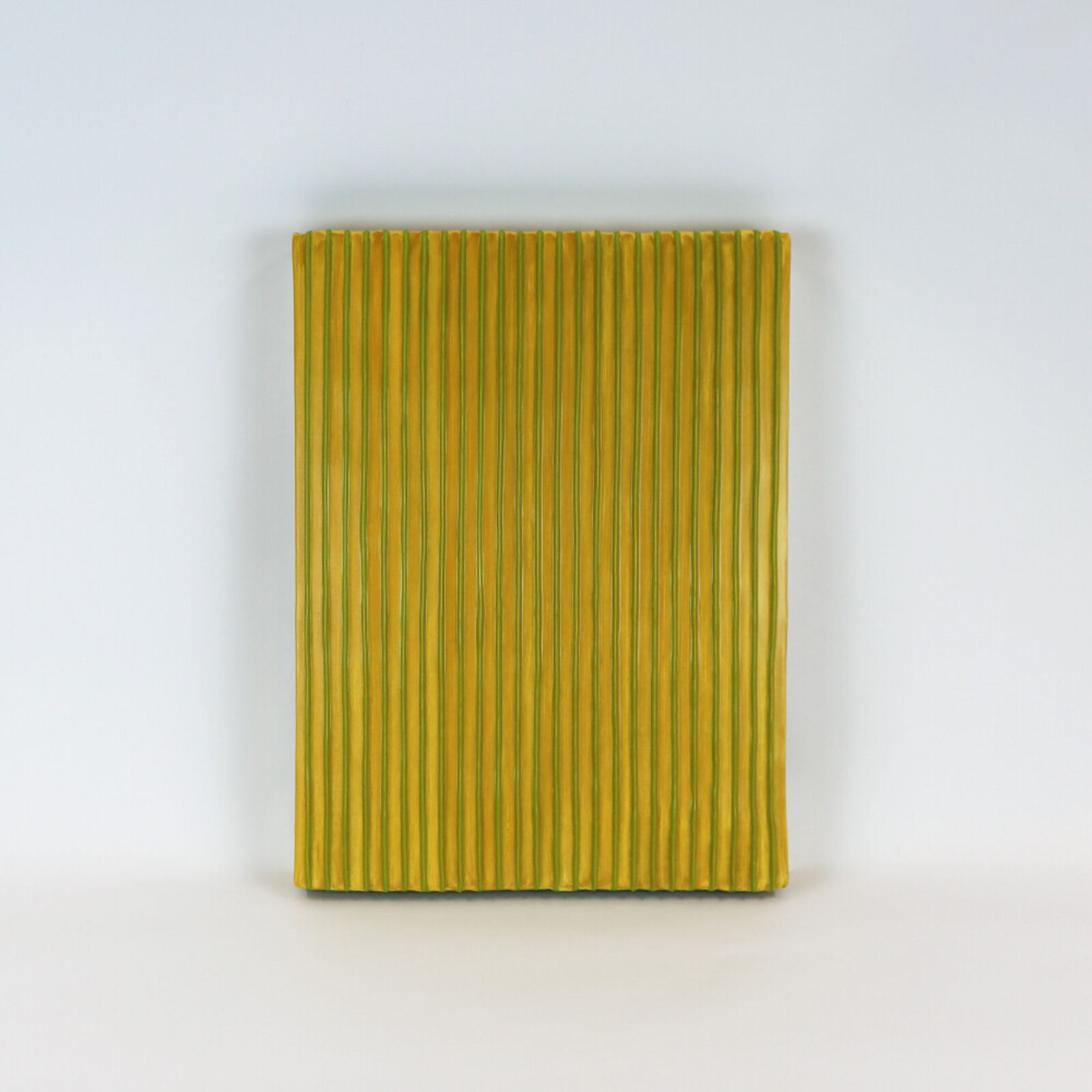 Two pieces of yellow and blue paper on a white surface.