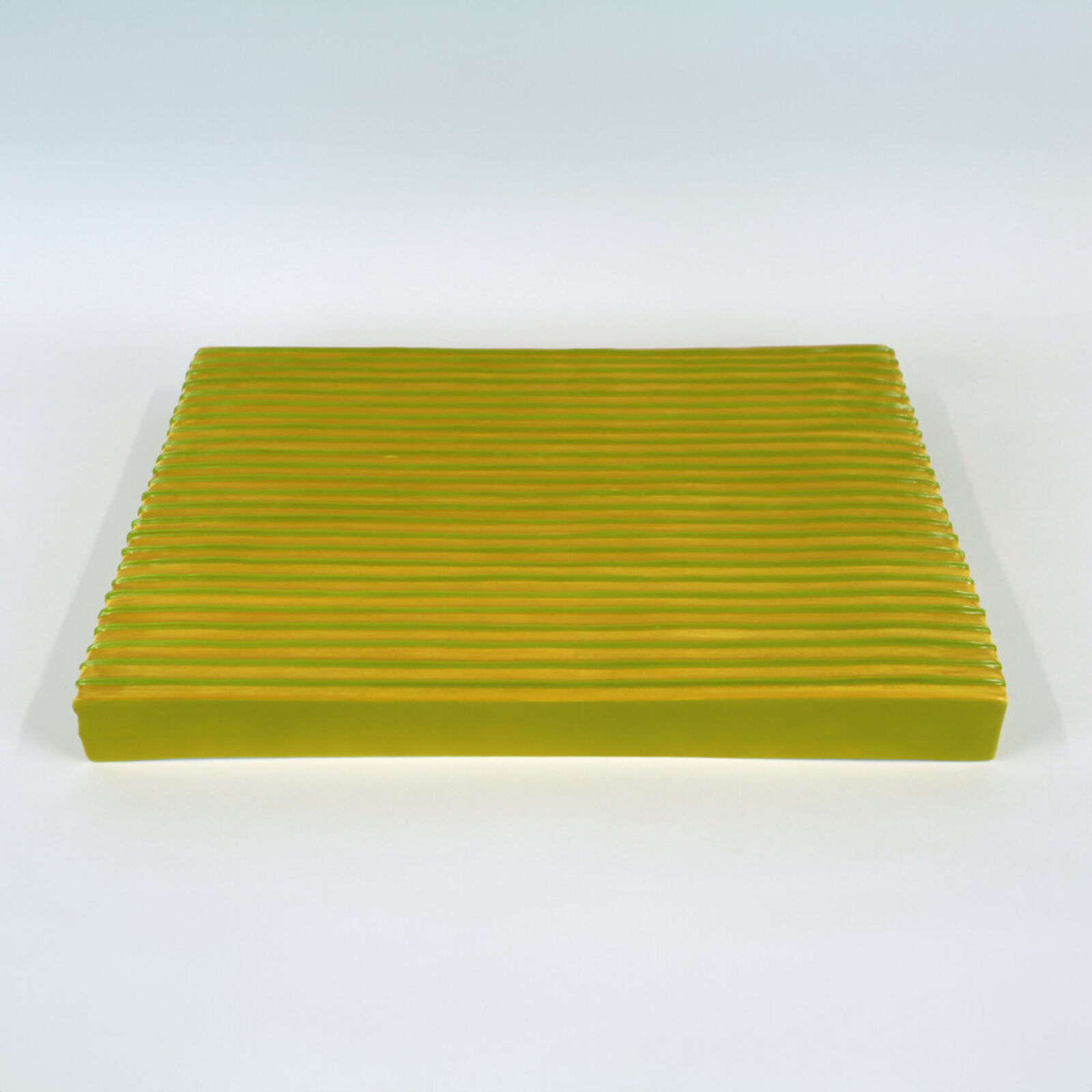 Two pieces of yellow and blue paper on a white surface.