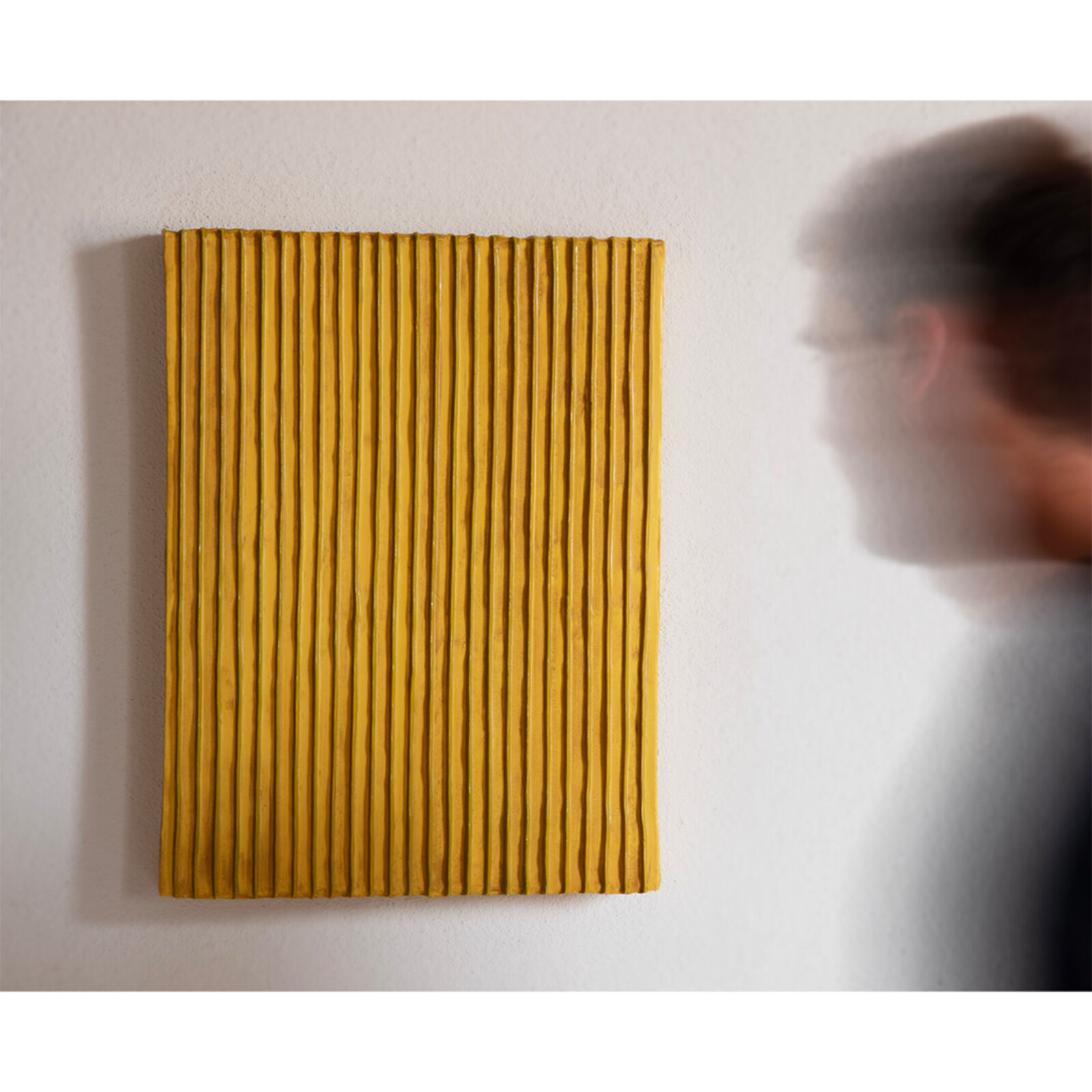 Two pieces of yellow and blue paper on a white surface.