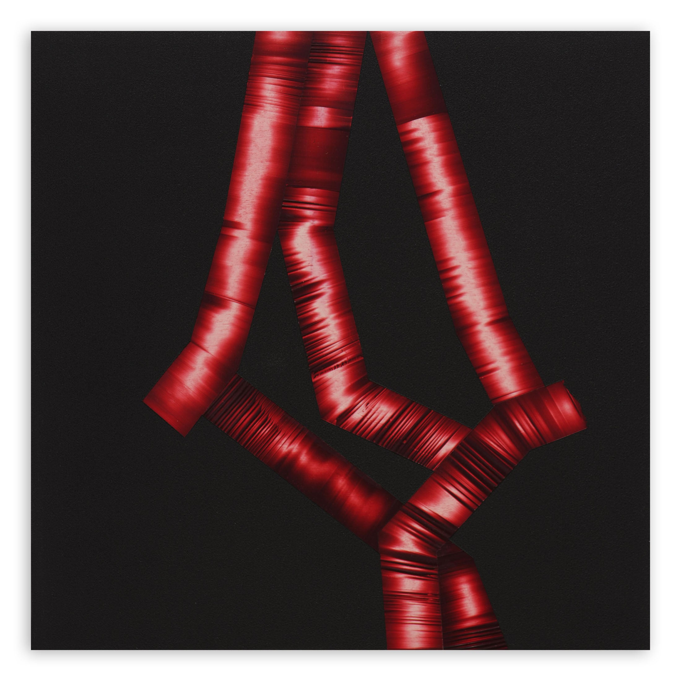 A black background with red ribbons on a black surface.