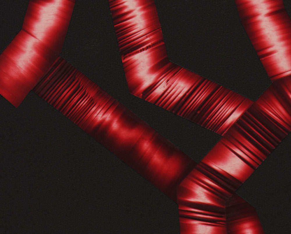 A black background with red ribbons on a black surface.