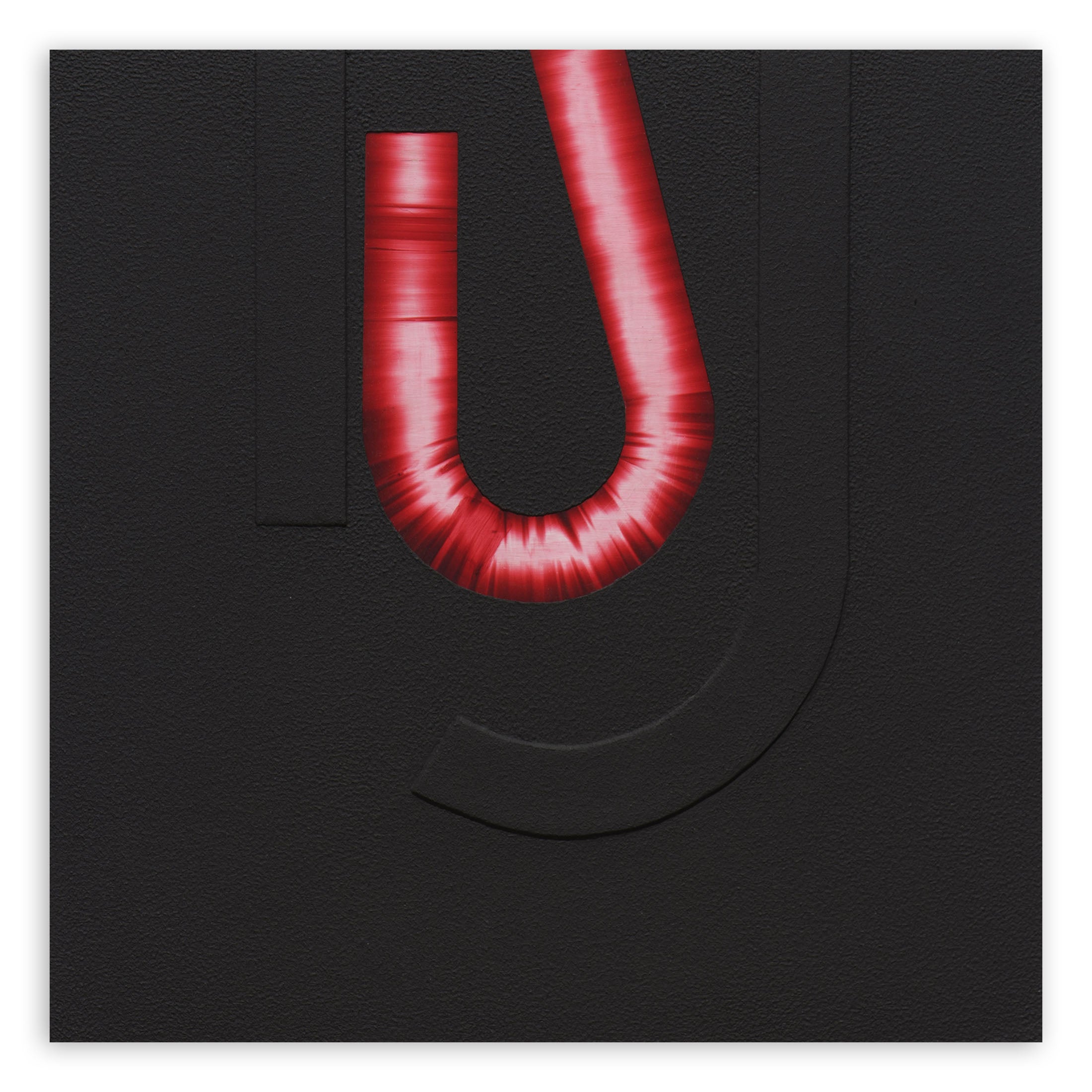 A red letter U on a black background. 
