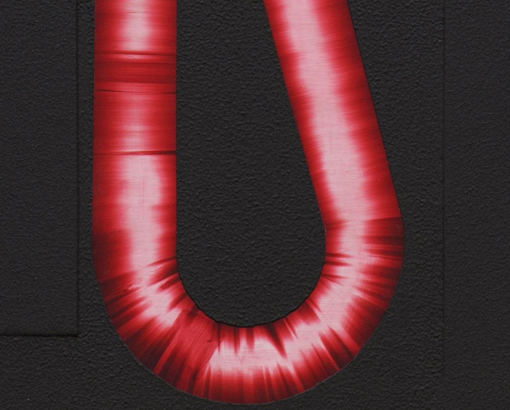 A red letter U on a black background. 