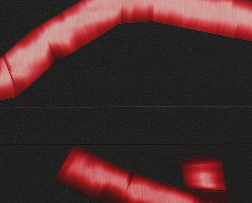 A black background with a red ribbon wrapped around it.
