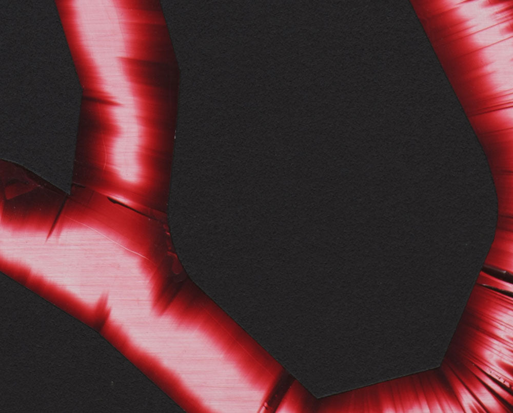 A red pipe on a black background. 