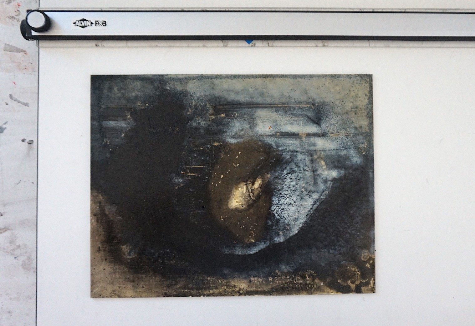 A dark, textured abstract composition featuring a central organic shape with peeling layers against a rough background.