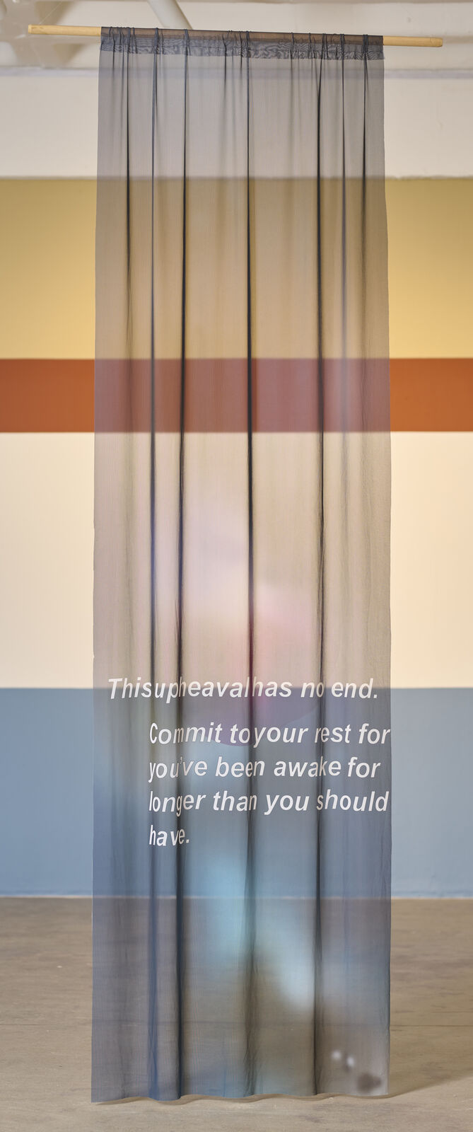 A room with a large painting on the wall and a blue light on the ceiling.