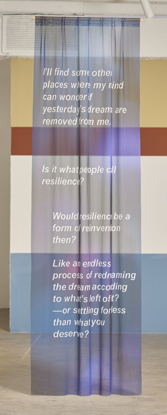 A room with a large painting on the wall and a blue light on the ceiling.