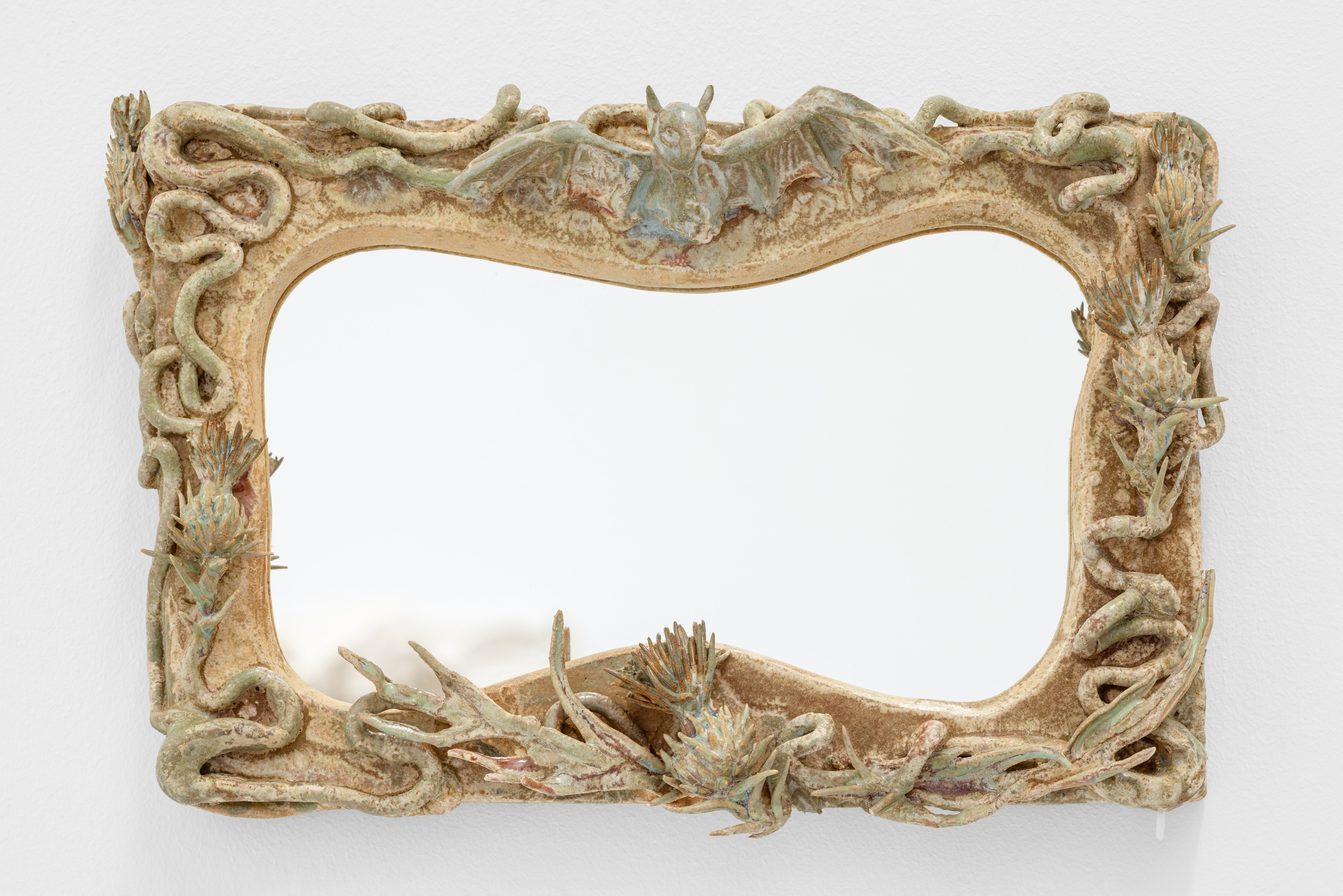 A picture frame with a dragon on top of it.