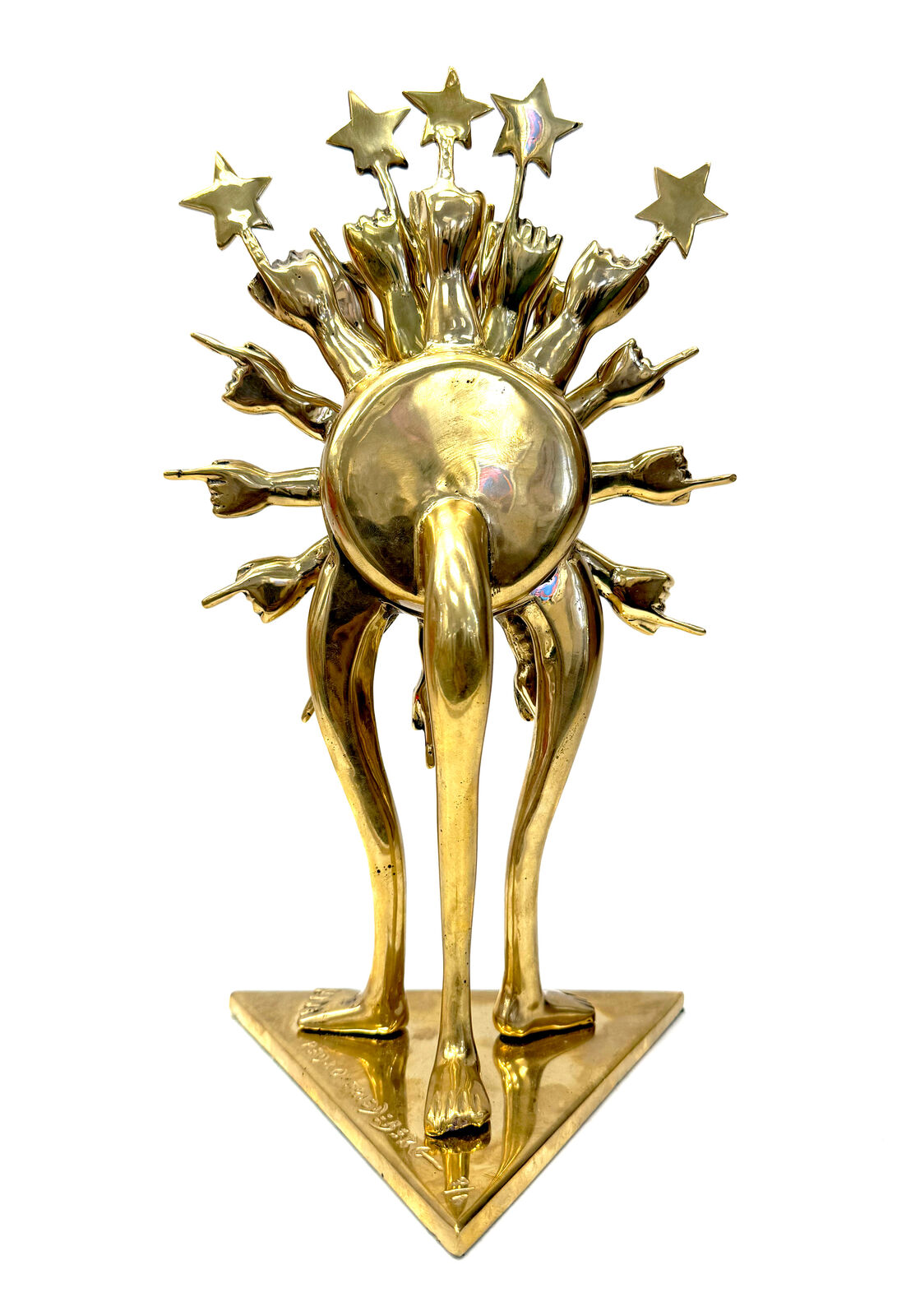 A gold clock with a sun and stars on top of it.