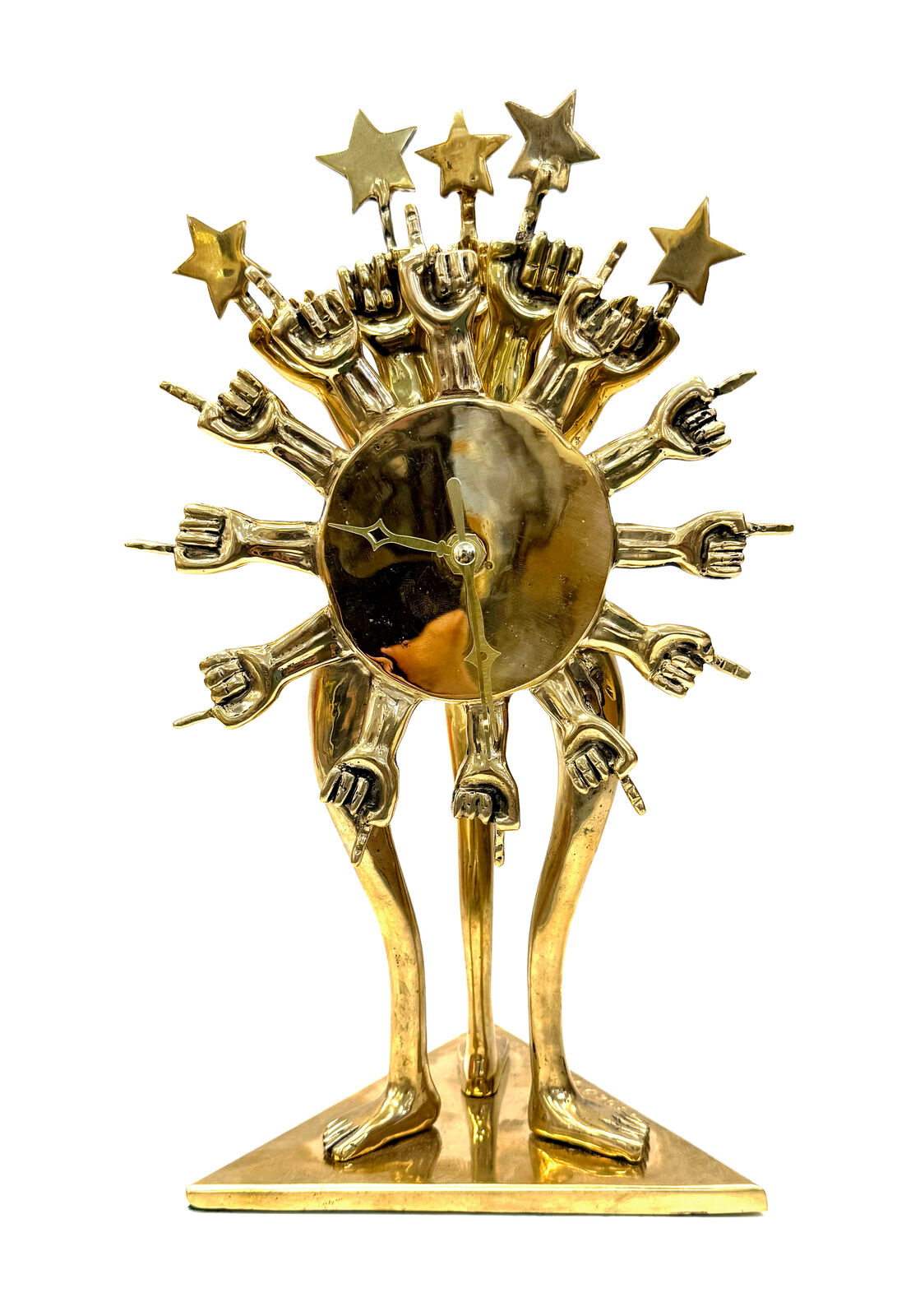 A gold clock with a sun and stars on top of it.