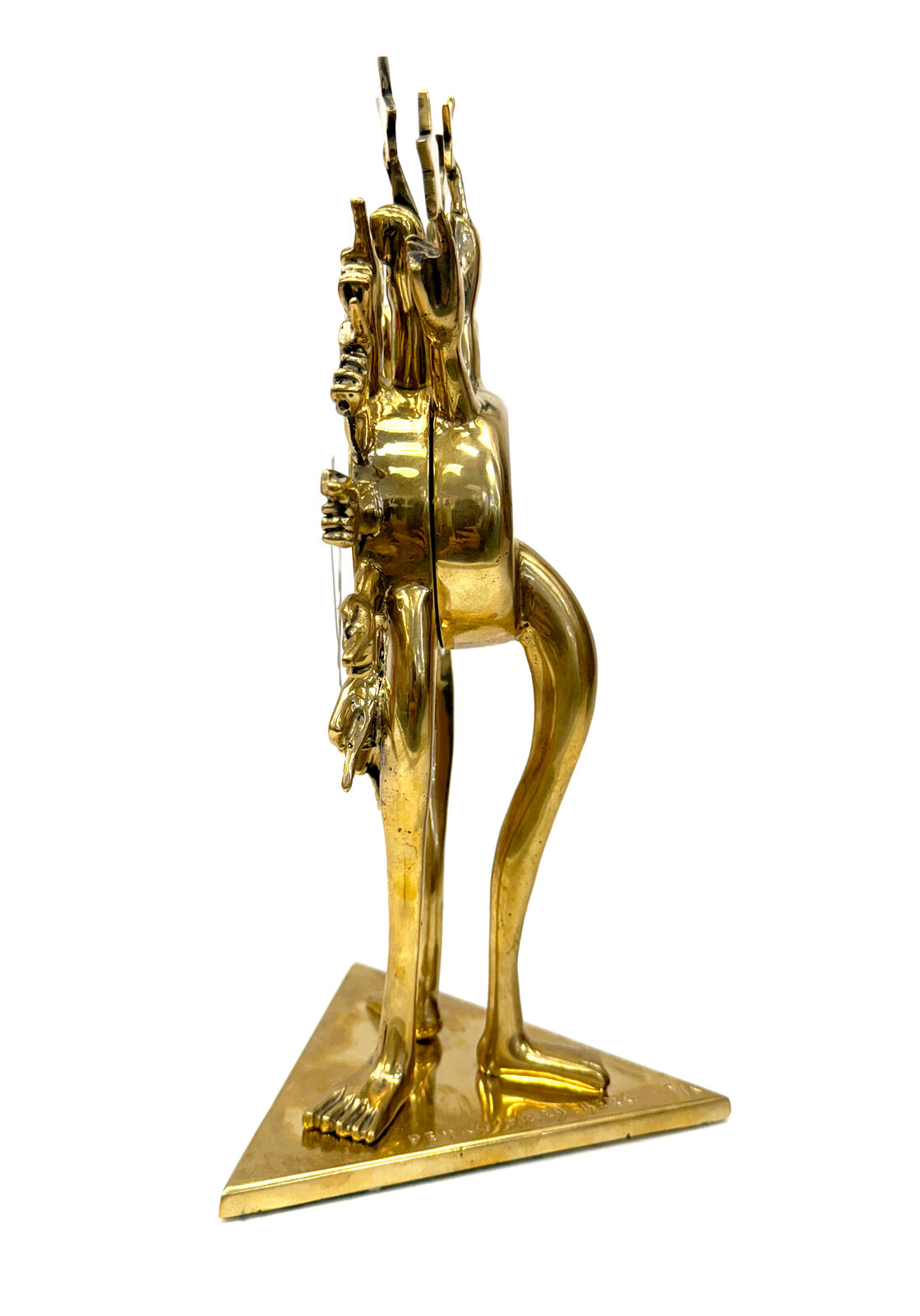 A gold clock with a sun and stars on top of it.