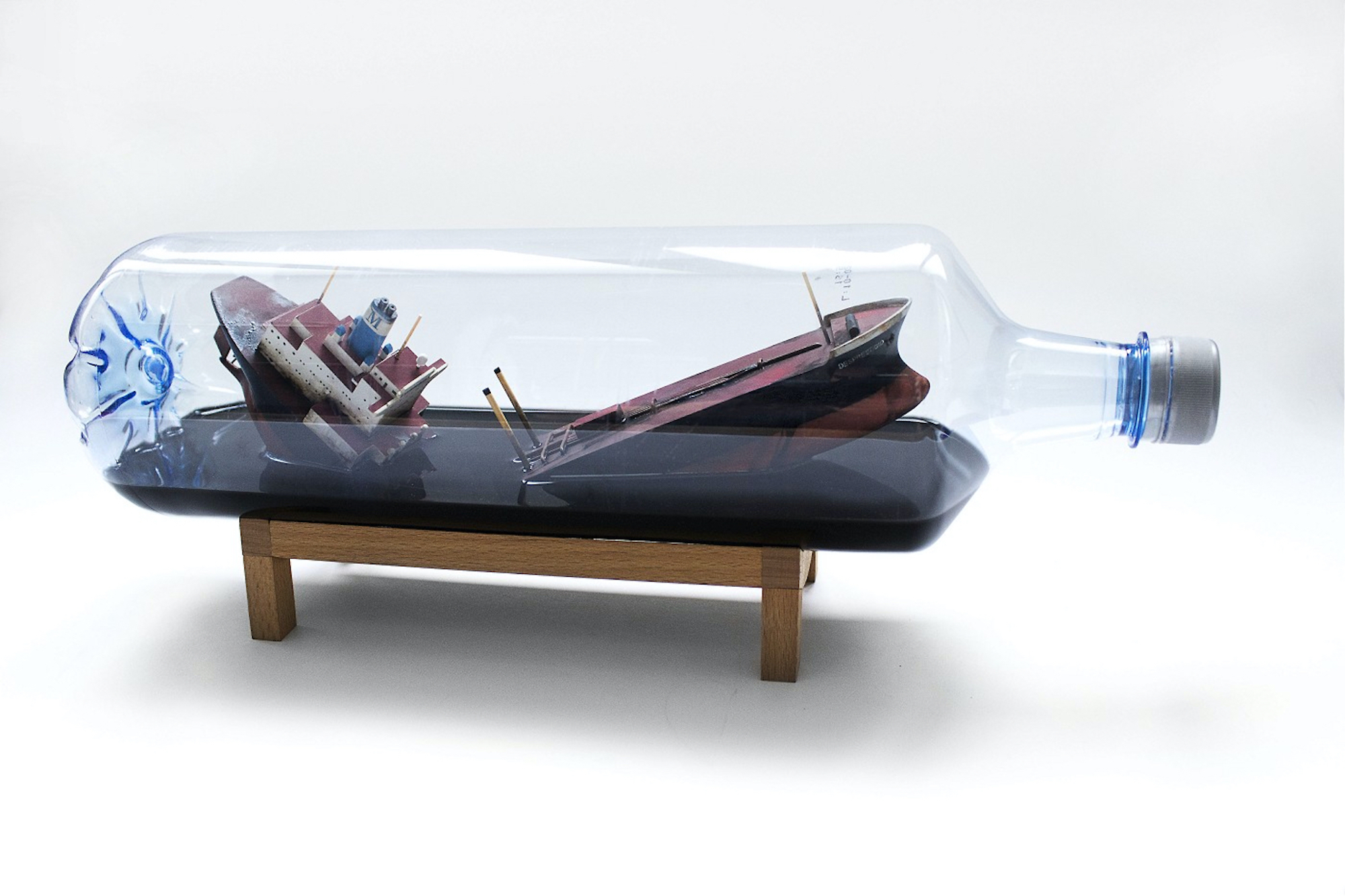 A ship in a bottle on a wooden stand.