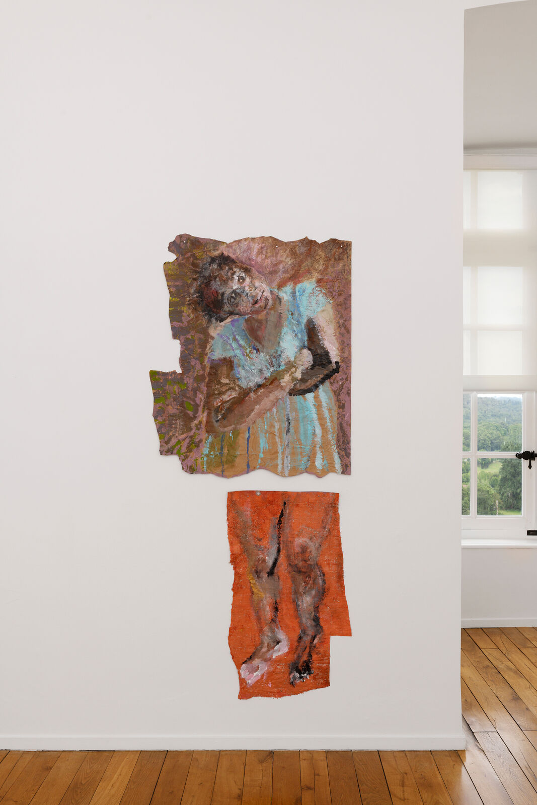 A painting hanging on a wall next to a window.