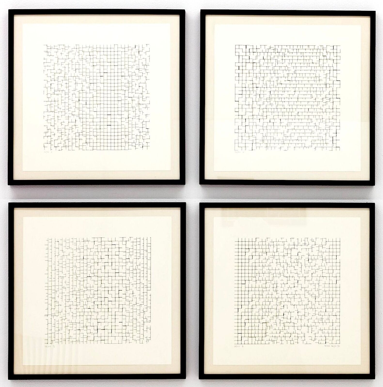 A set of four black and white crossword puzzles on a wall.
