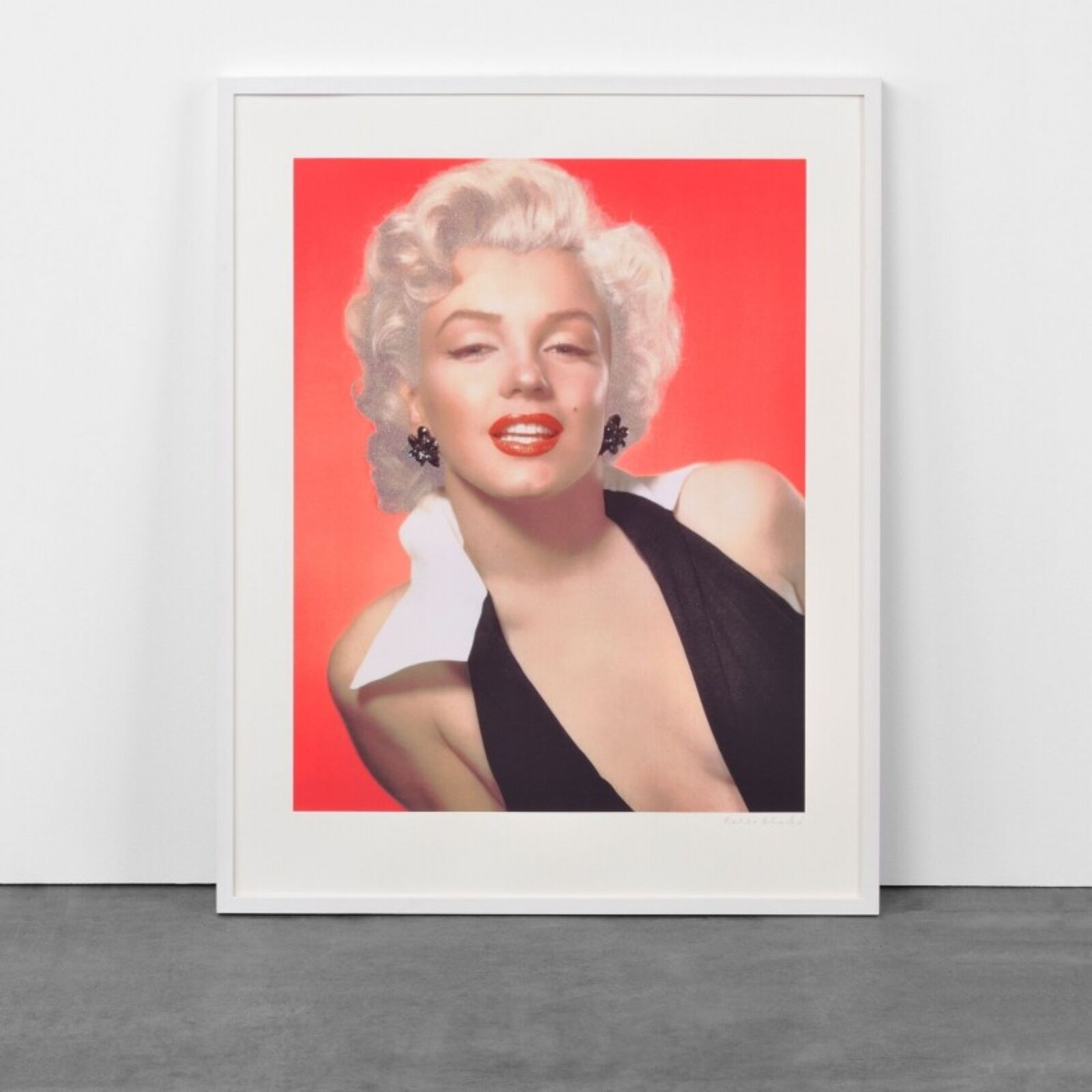 A framed photograph of a woman in a black dress.