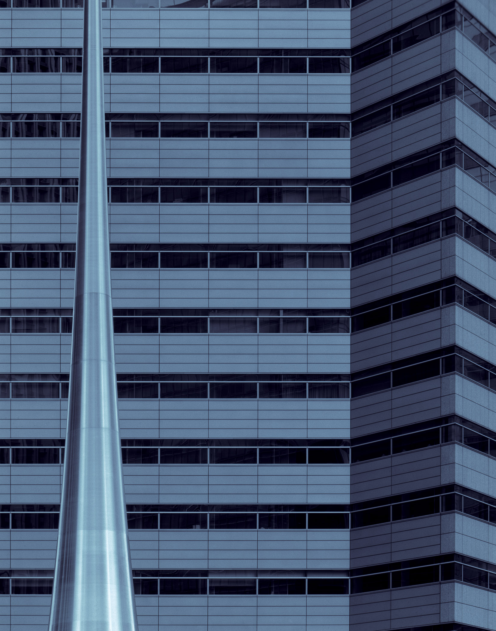 A tall building with many windows in the middle of it.