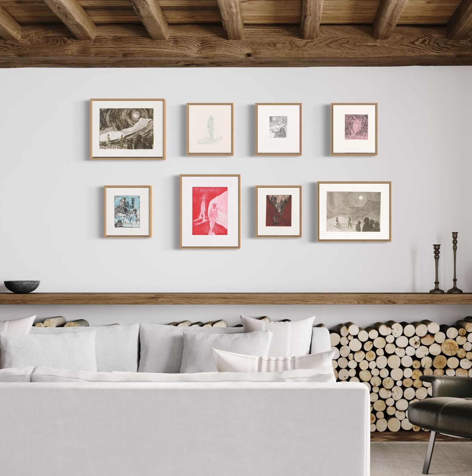 A wall of framed pictures on a white wall in a room.