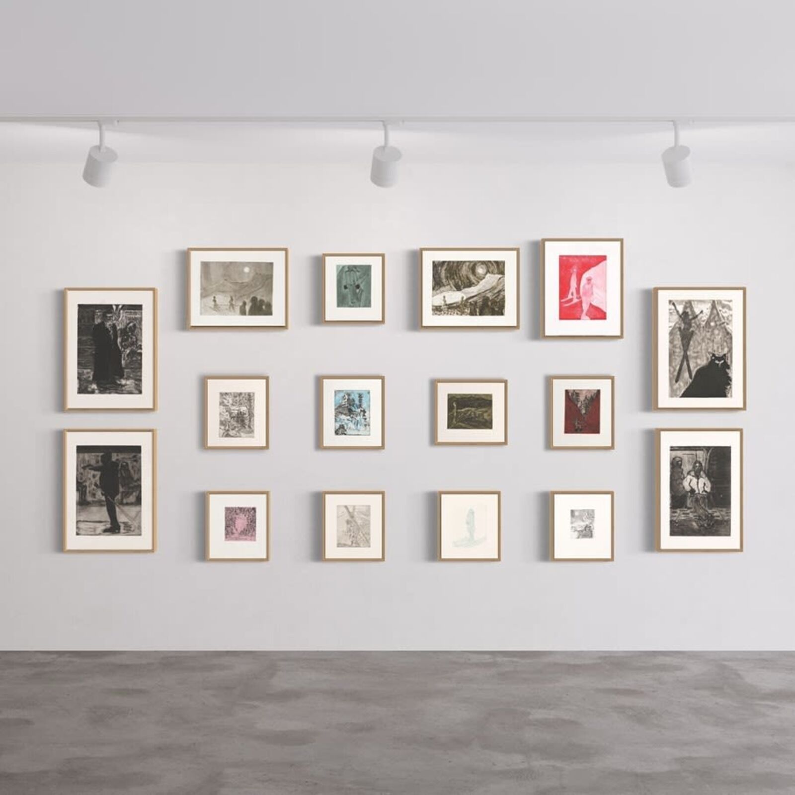 A wall of framed pictures on a white wall in a room.