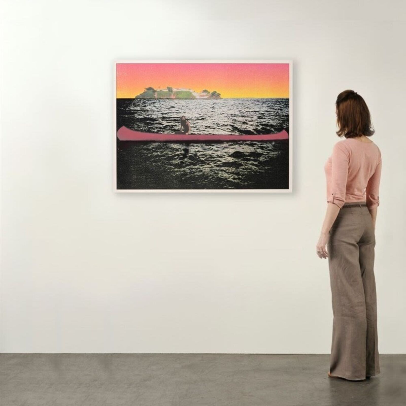 A woman standing in front of a painting on a wall.