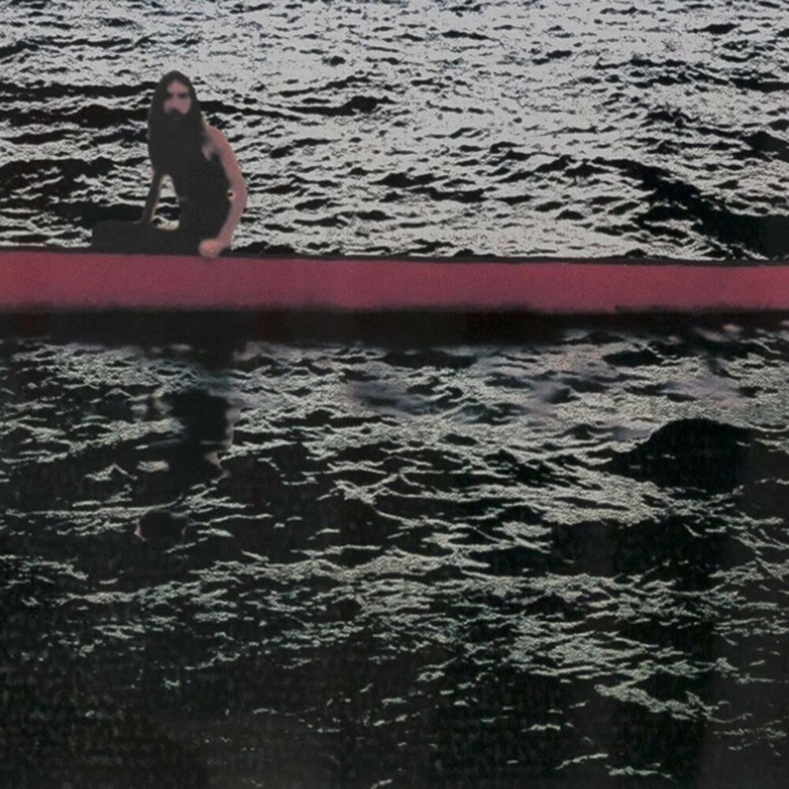 A woman standing in front of a painting on a wall.