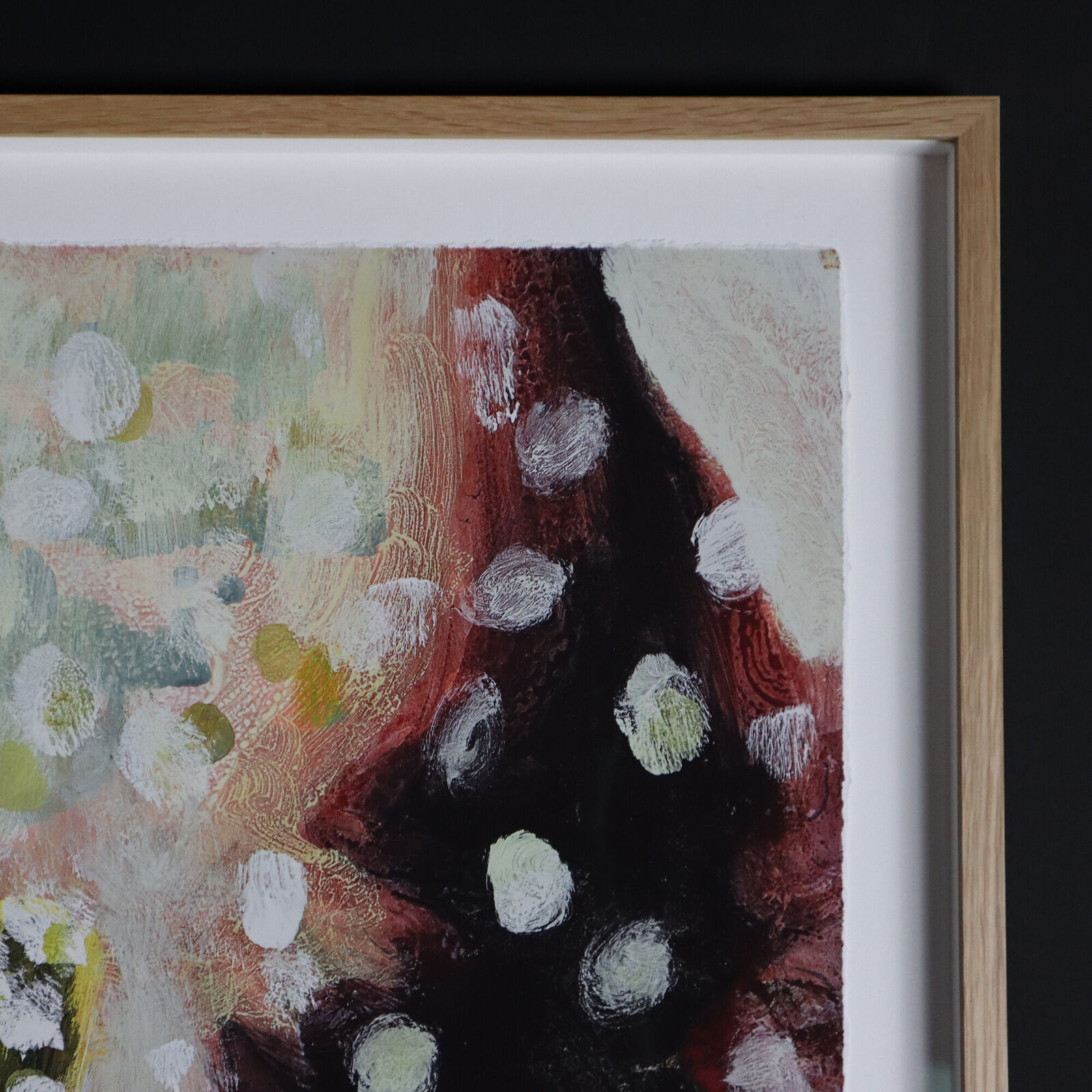 A group of paintings hanging on a wall in a room.