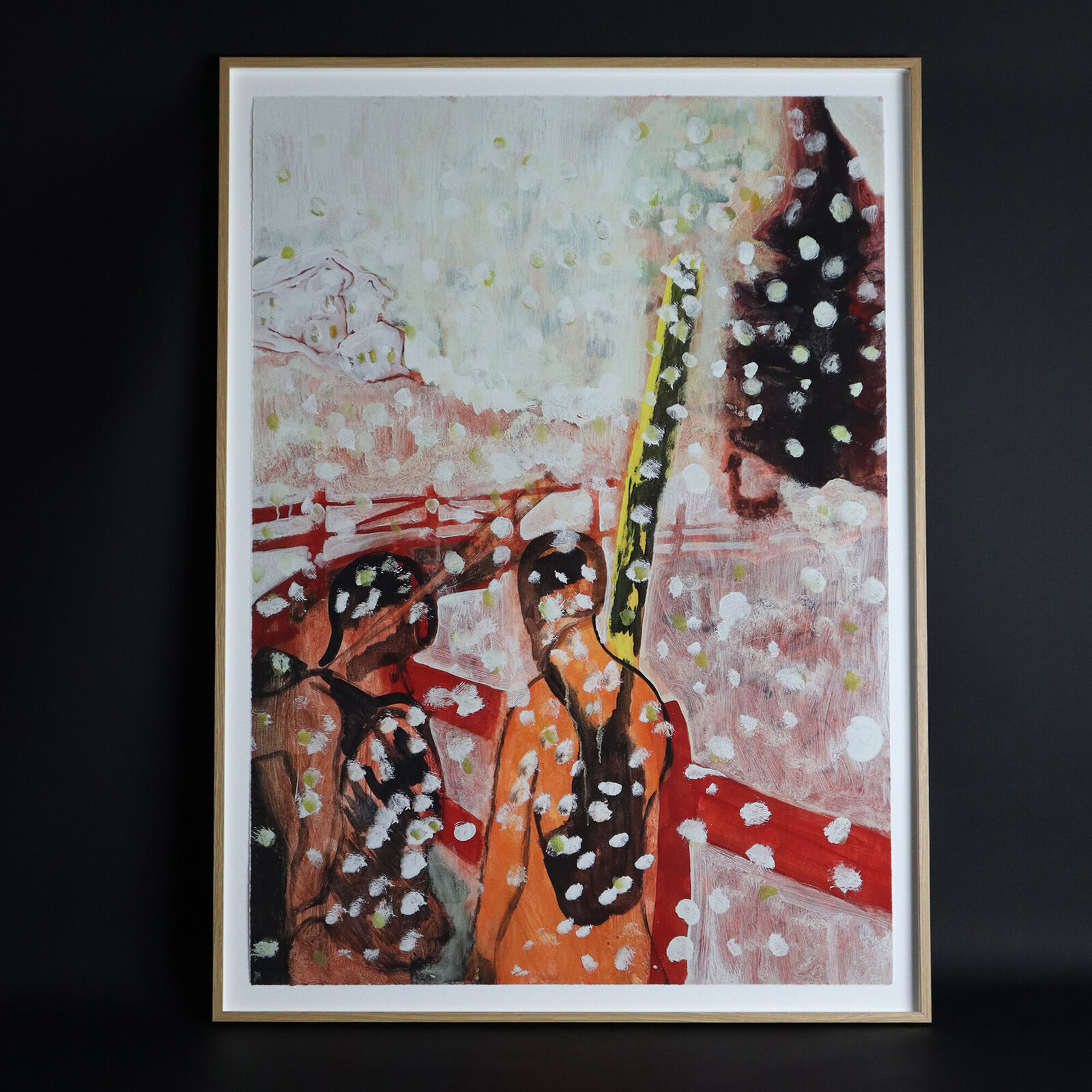 A group of paintings hanging on a wall in a room.