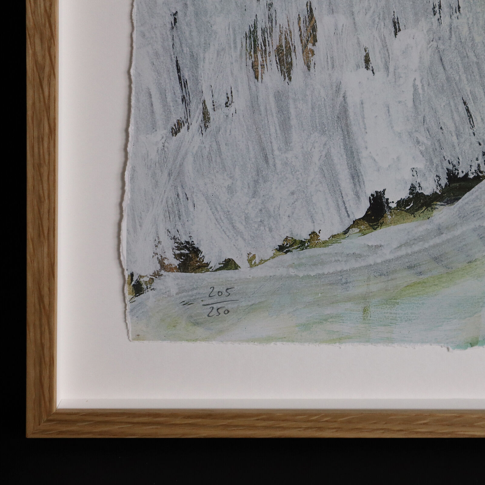 A group of paintings hanging on a wall in a room.