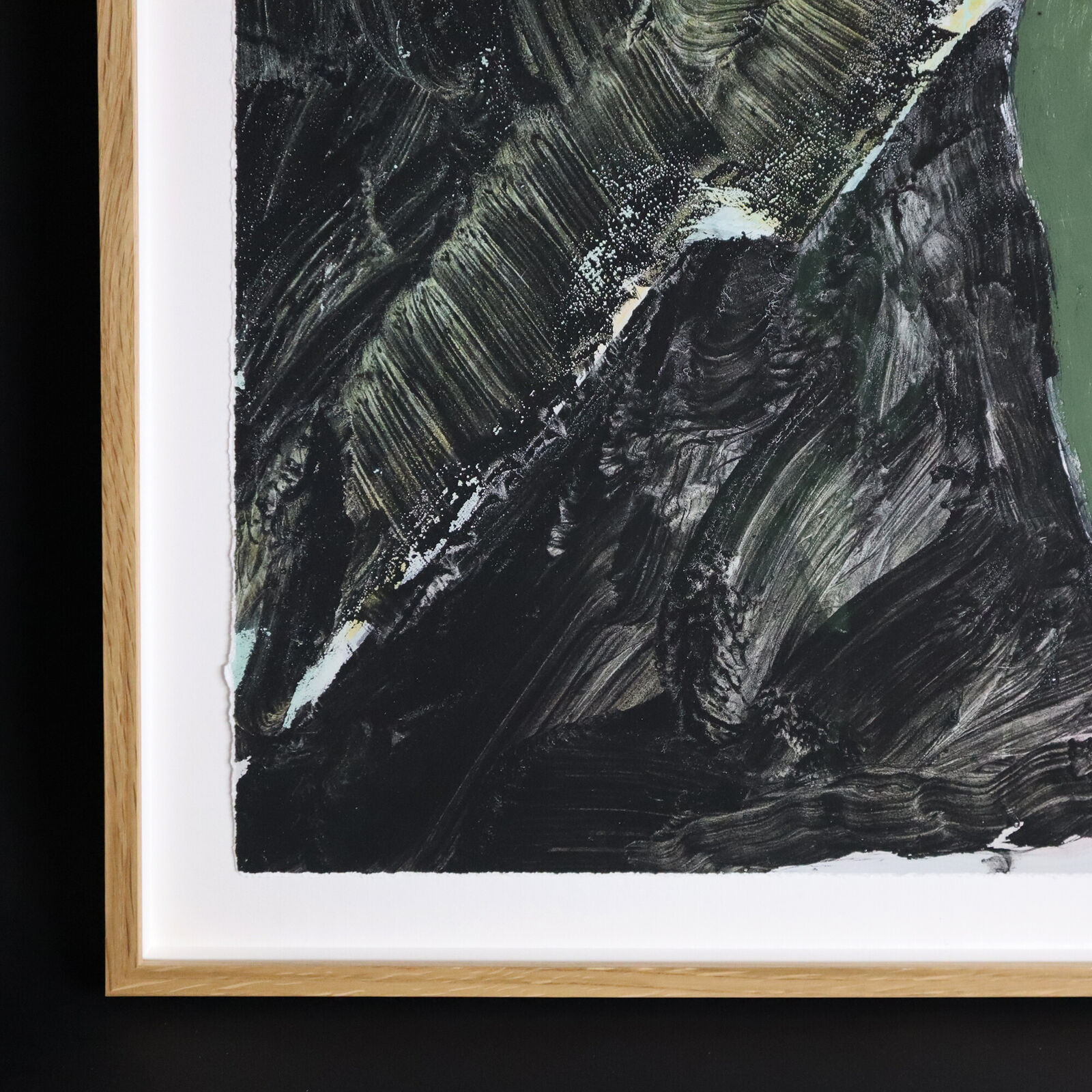 A group of paintings hanging on a wall in a room.