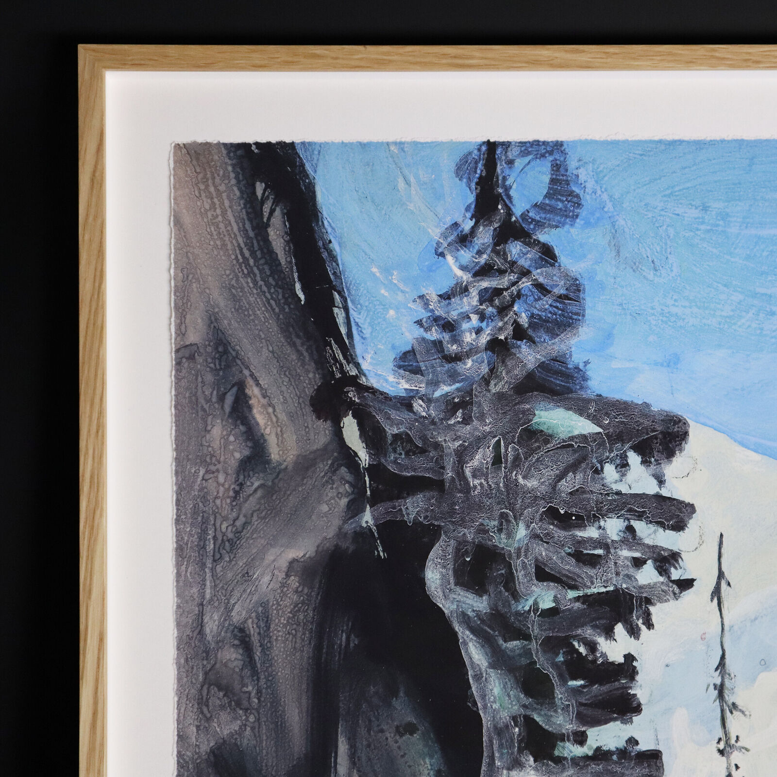 A group of paintings hanging on a wall in a room.