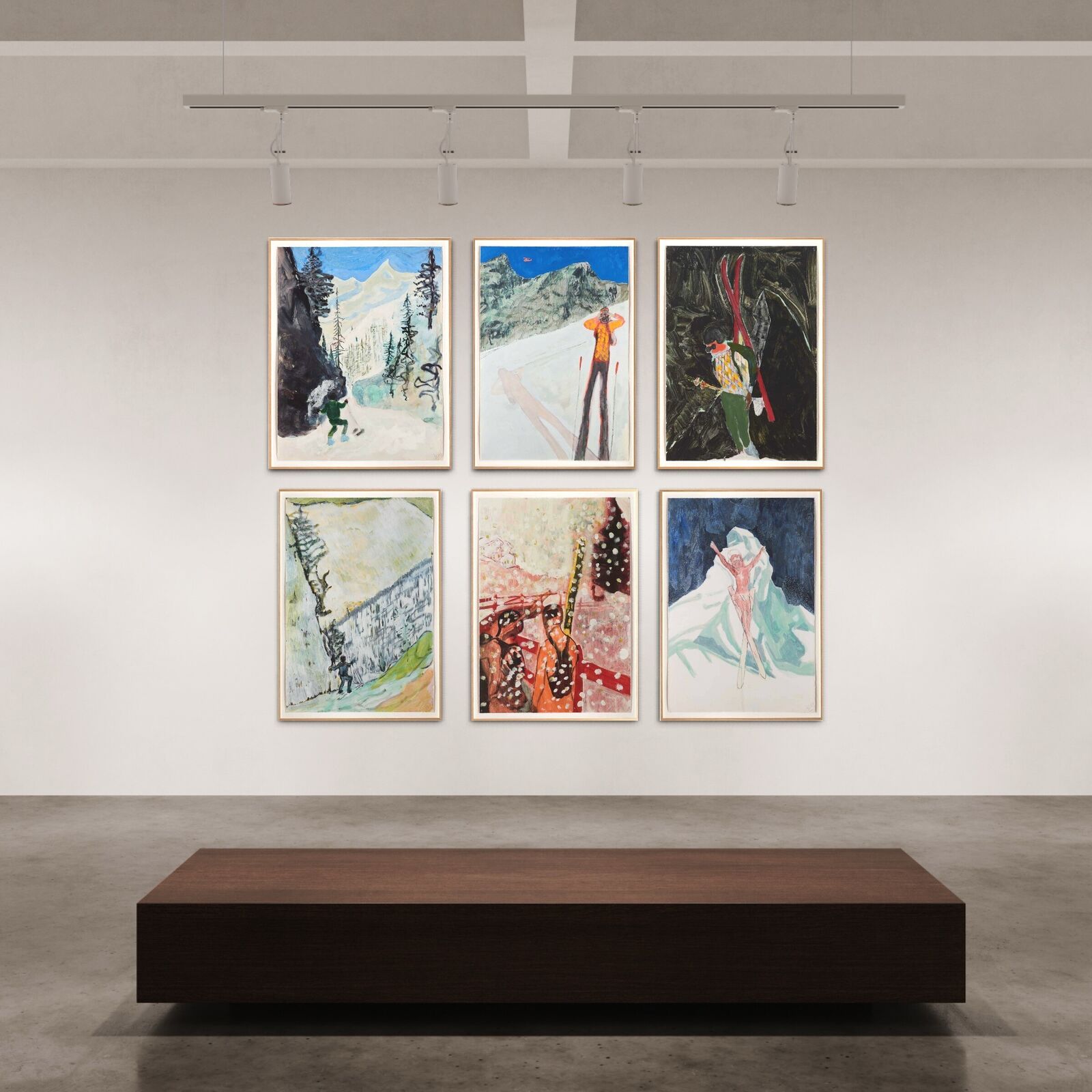 A group of paintings hanging on a wall in a room.