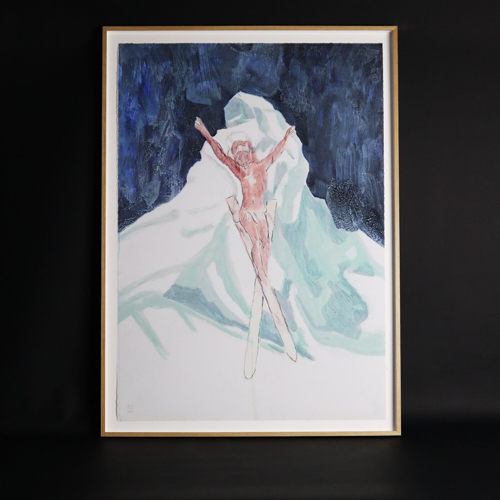 A group of paintings hanging on a wall in a room.