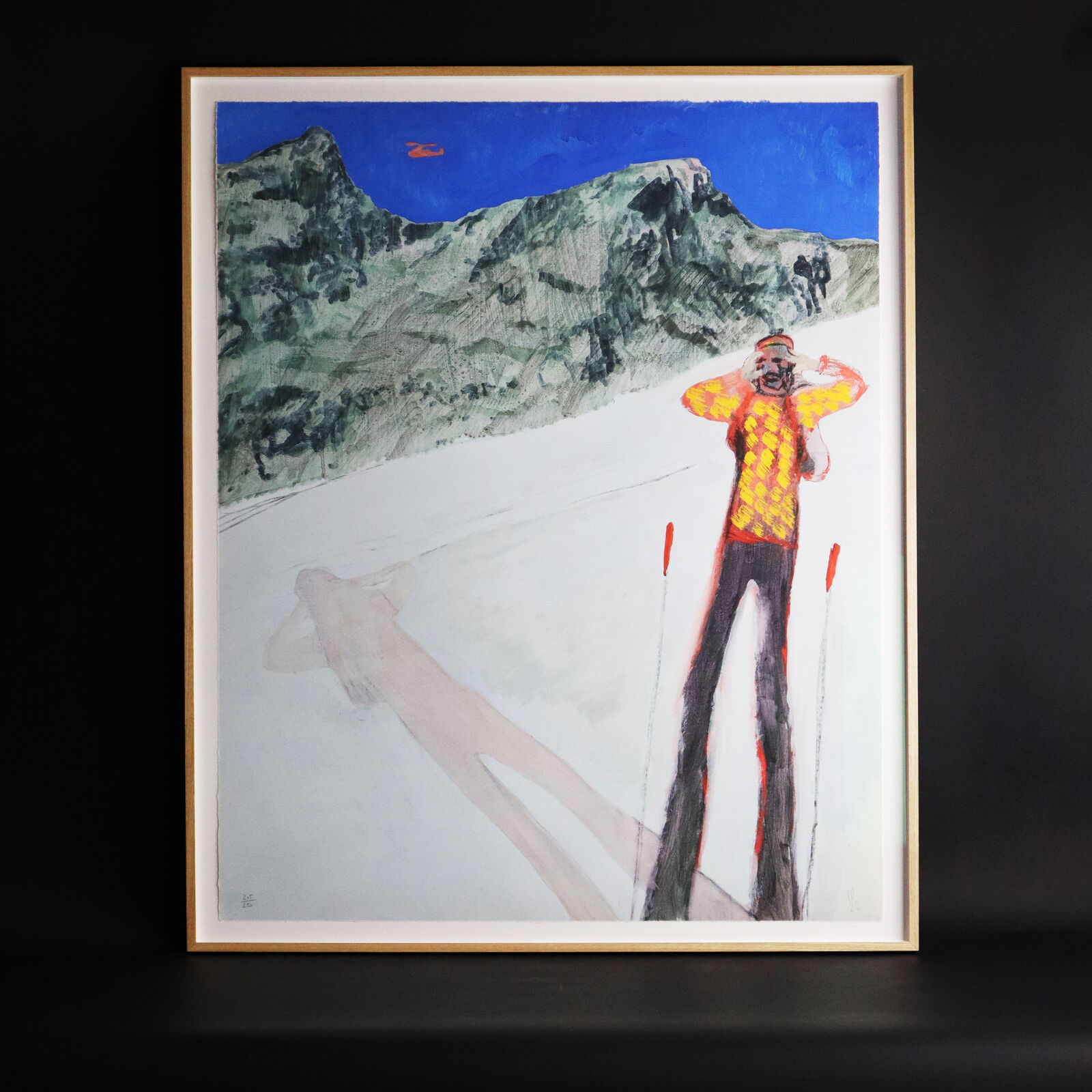 A group of paintings hanging on a wall in a room.