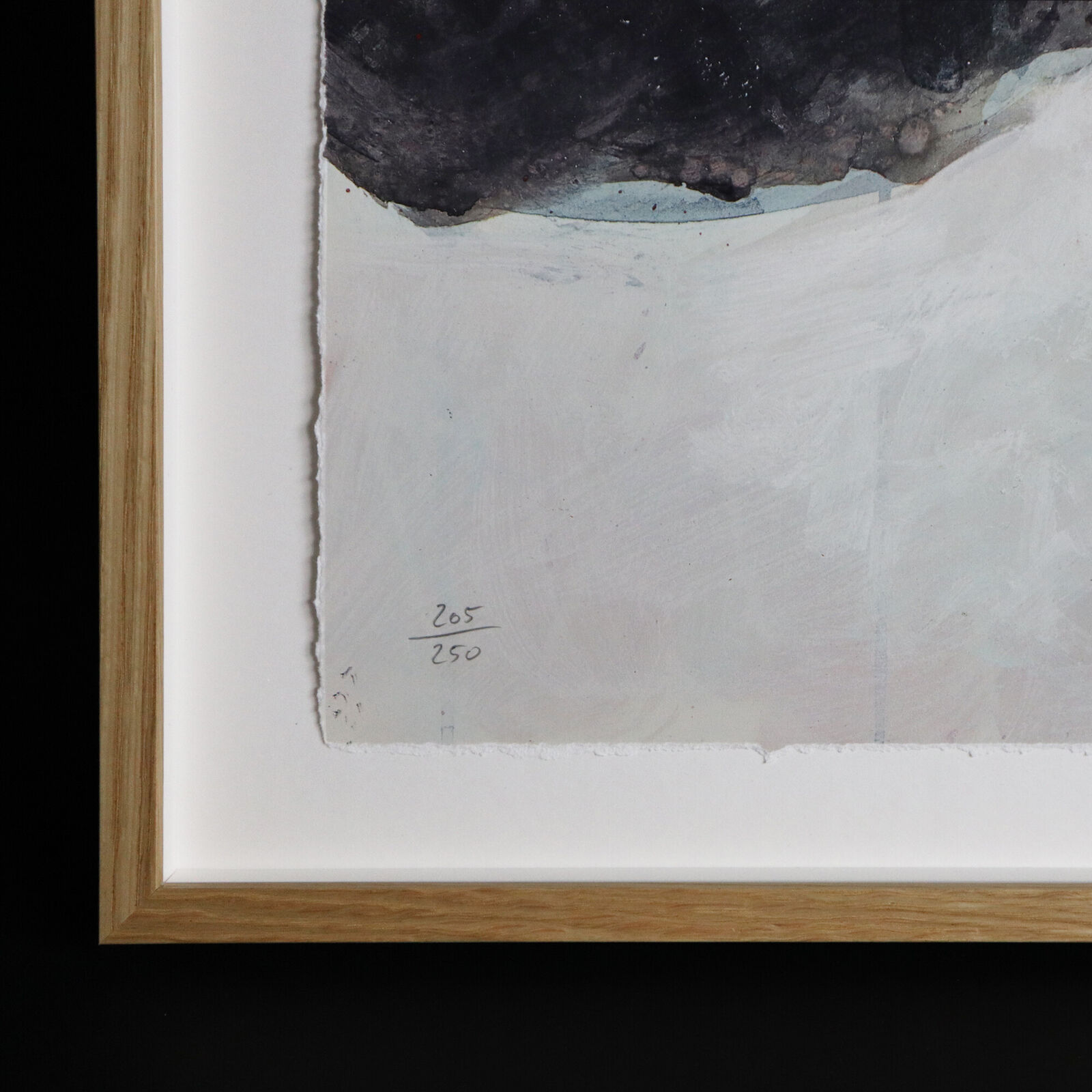 A group of paintings hanging on a wall in a room.