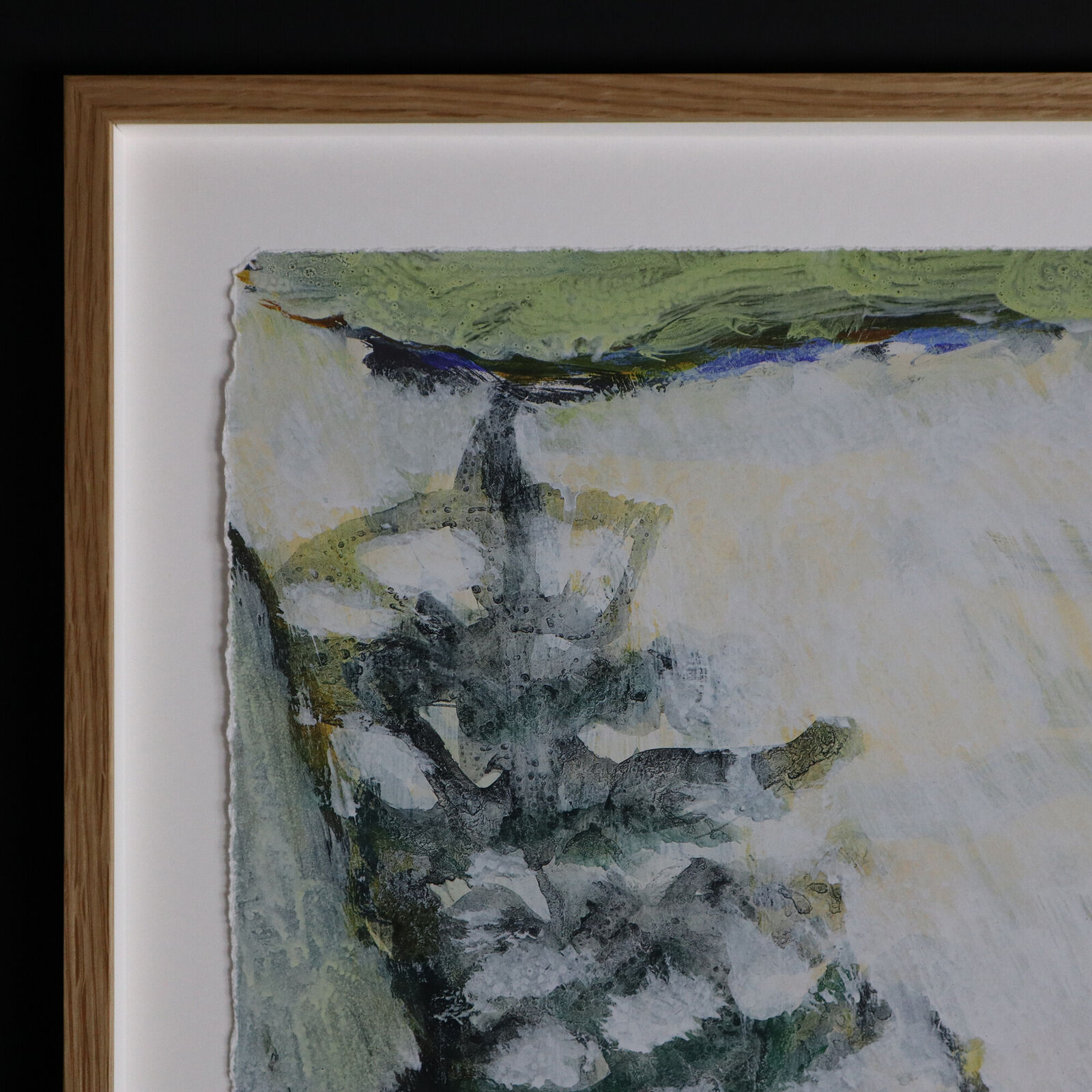 A group of paintings hanging on a wall in a room.