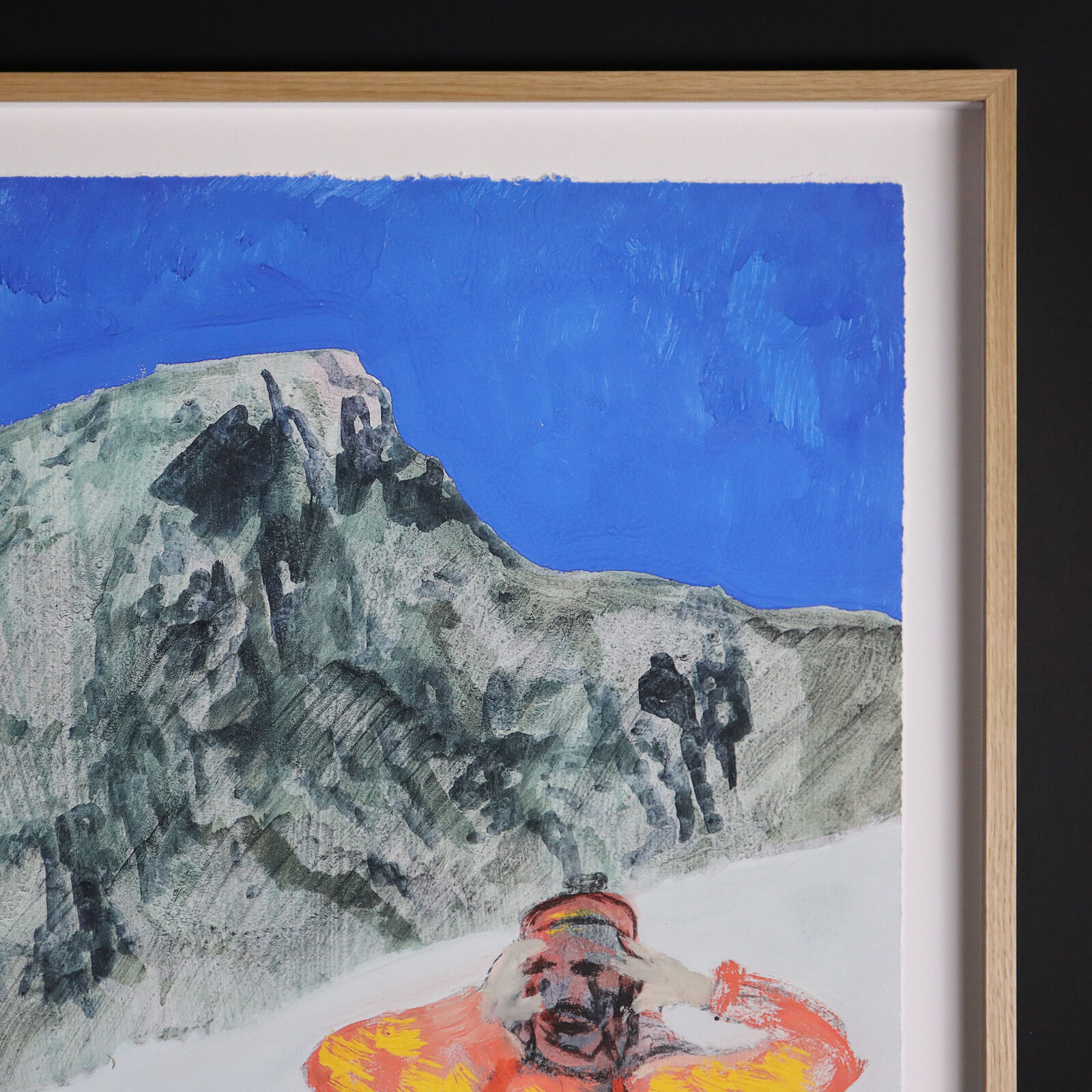 A group of paintings hanging on a wall in a room.