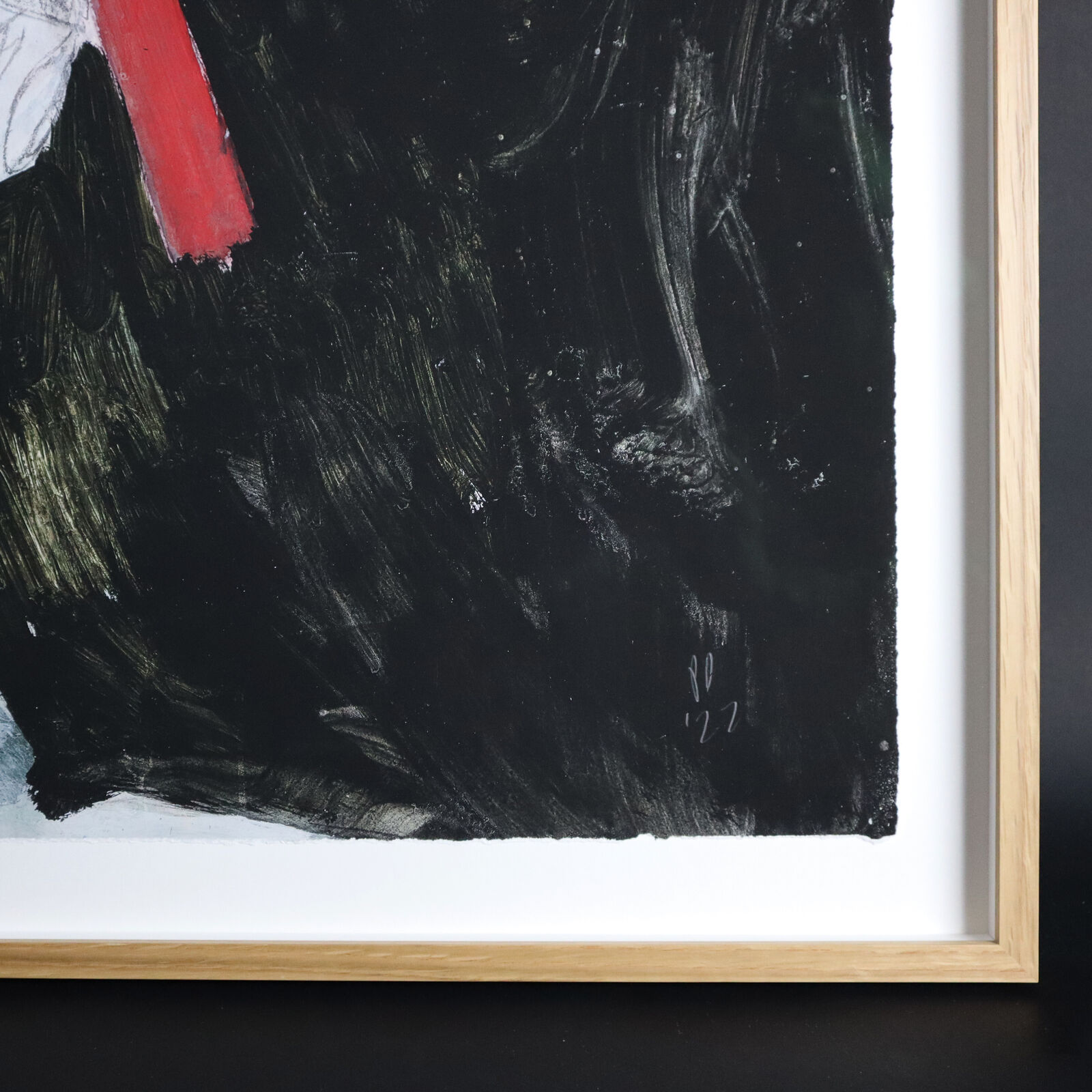 A group of paintings hanging on a wall in a room.