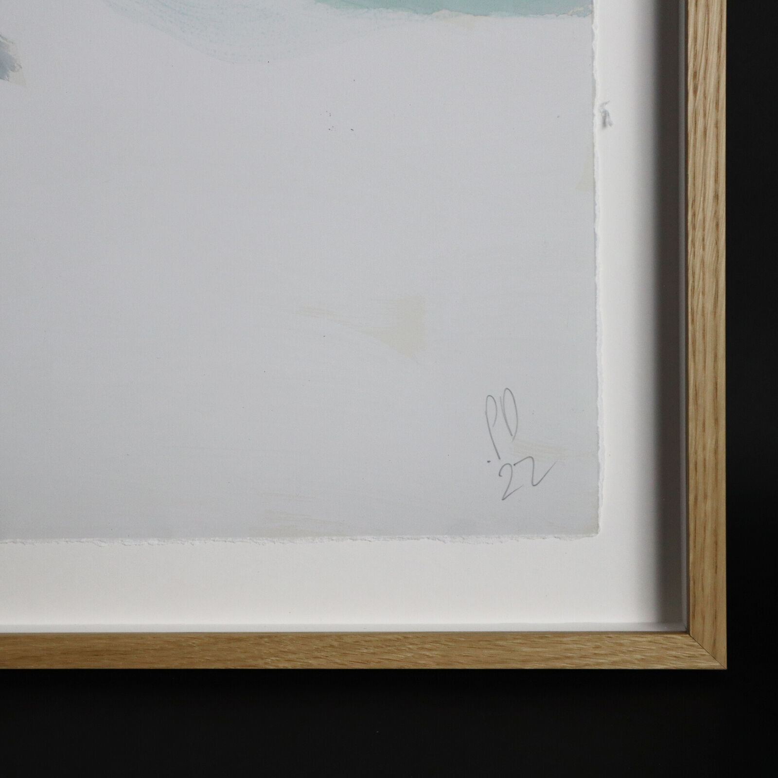 A group of paintings hanging on a wall in a room.