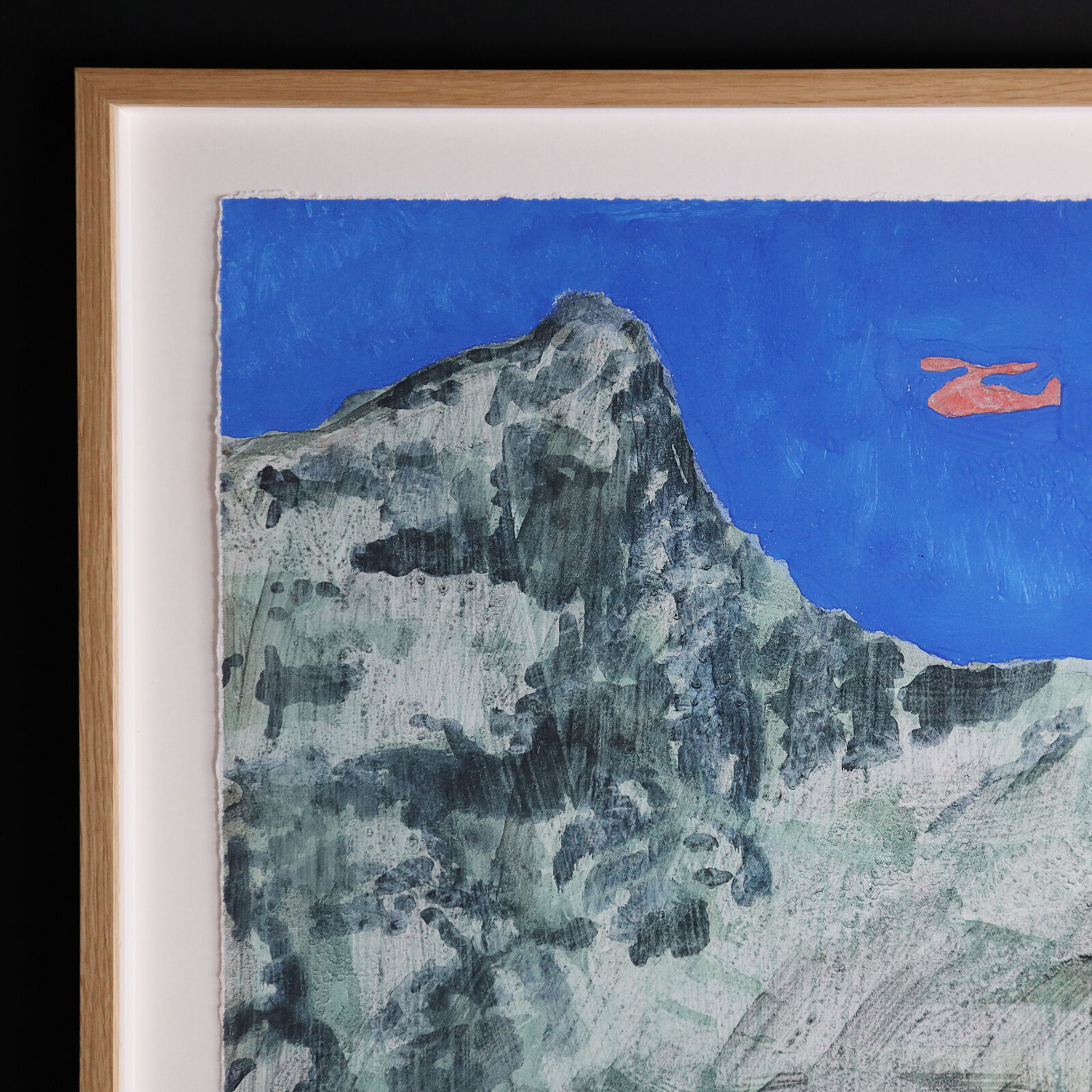 A group of paintings hanging on a wall in a room.