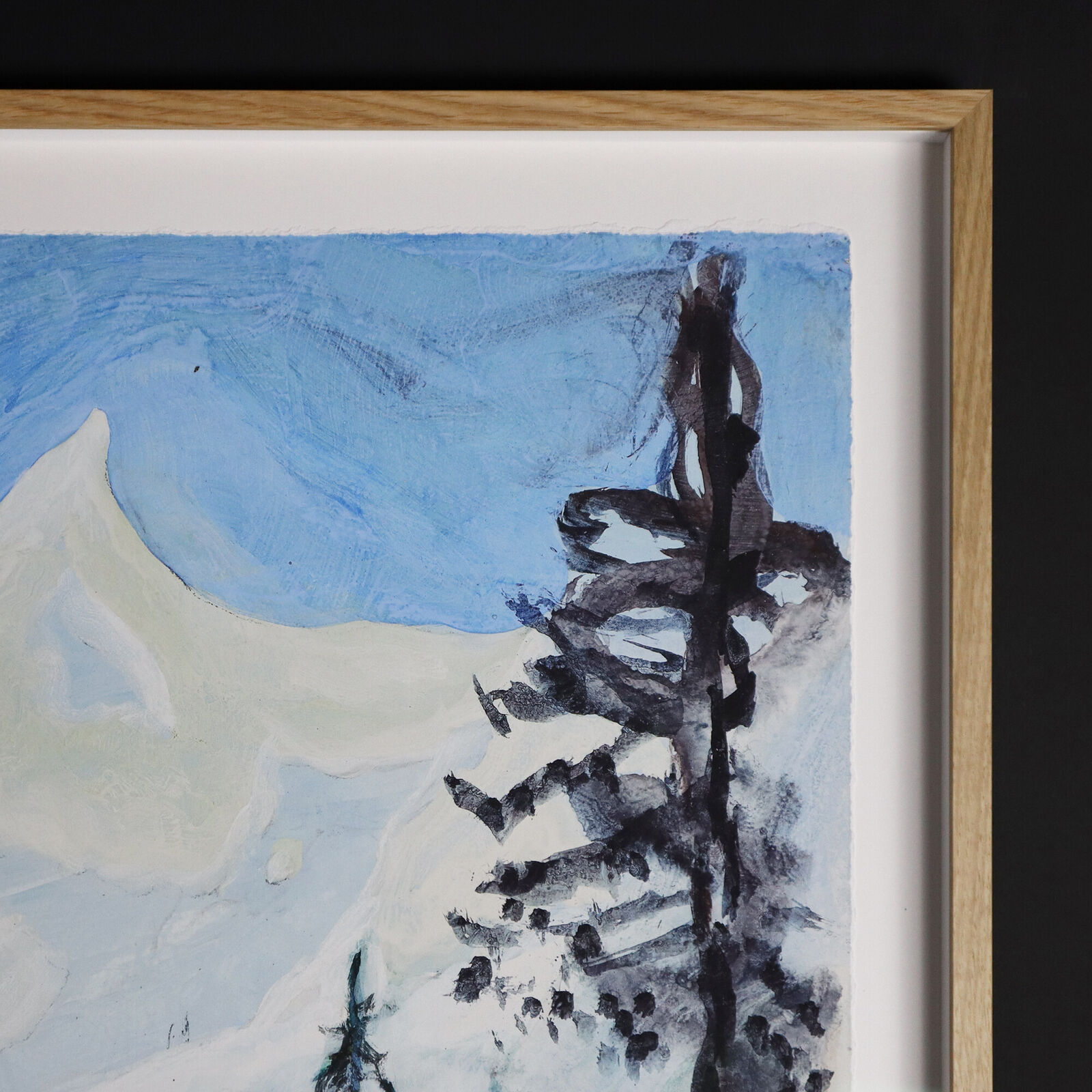 A group of paintings hanging on a wall in a room.