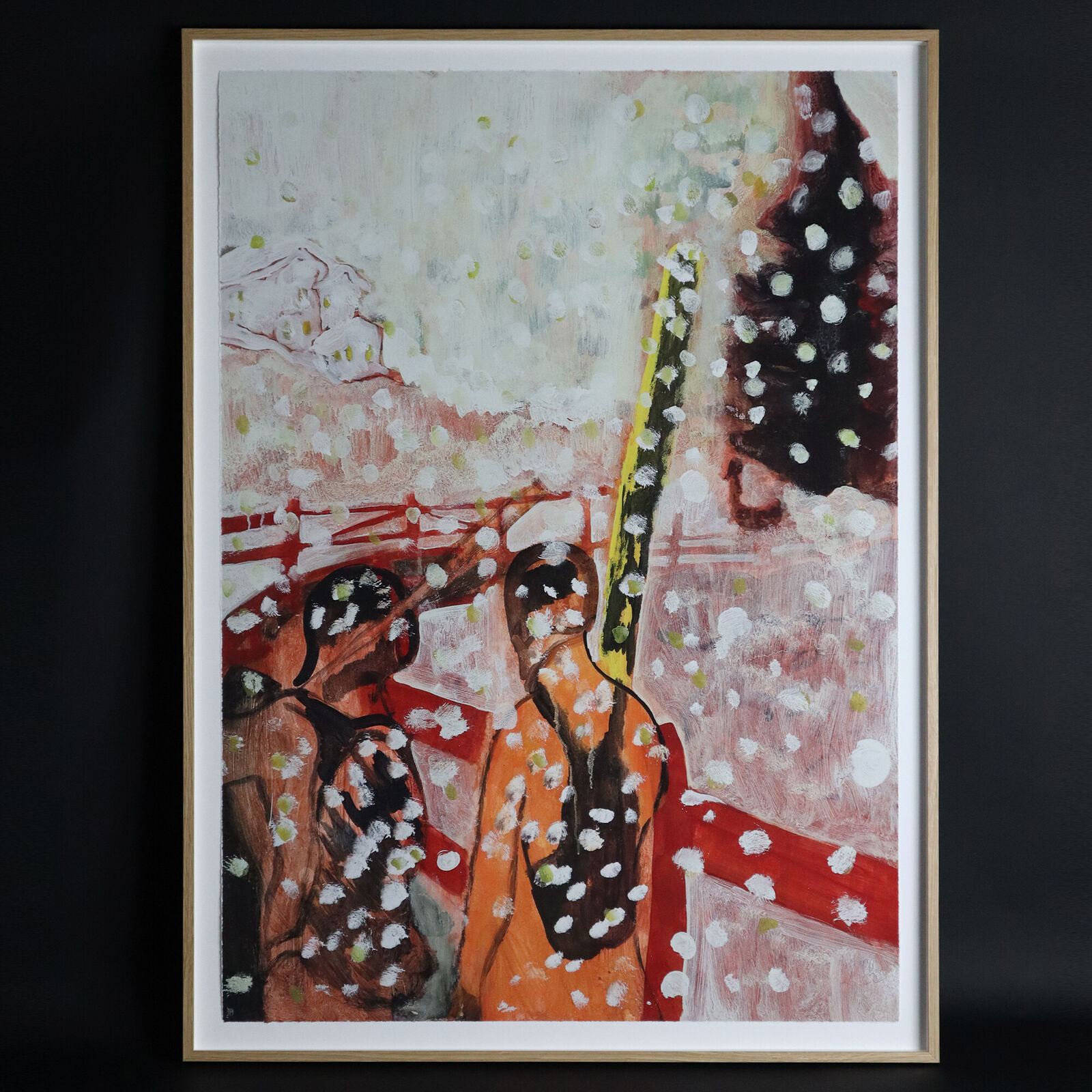 A group of paintings hanging on a wall in a room.