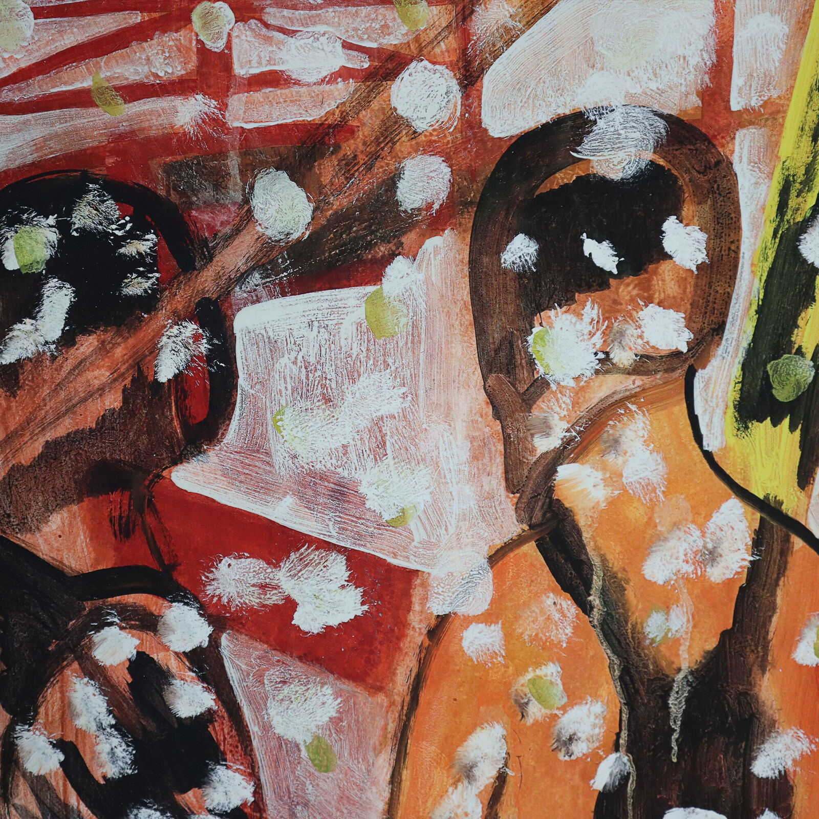 A group of paintings hanging on a wall in a room.