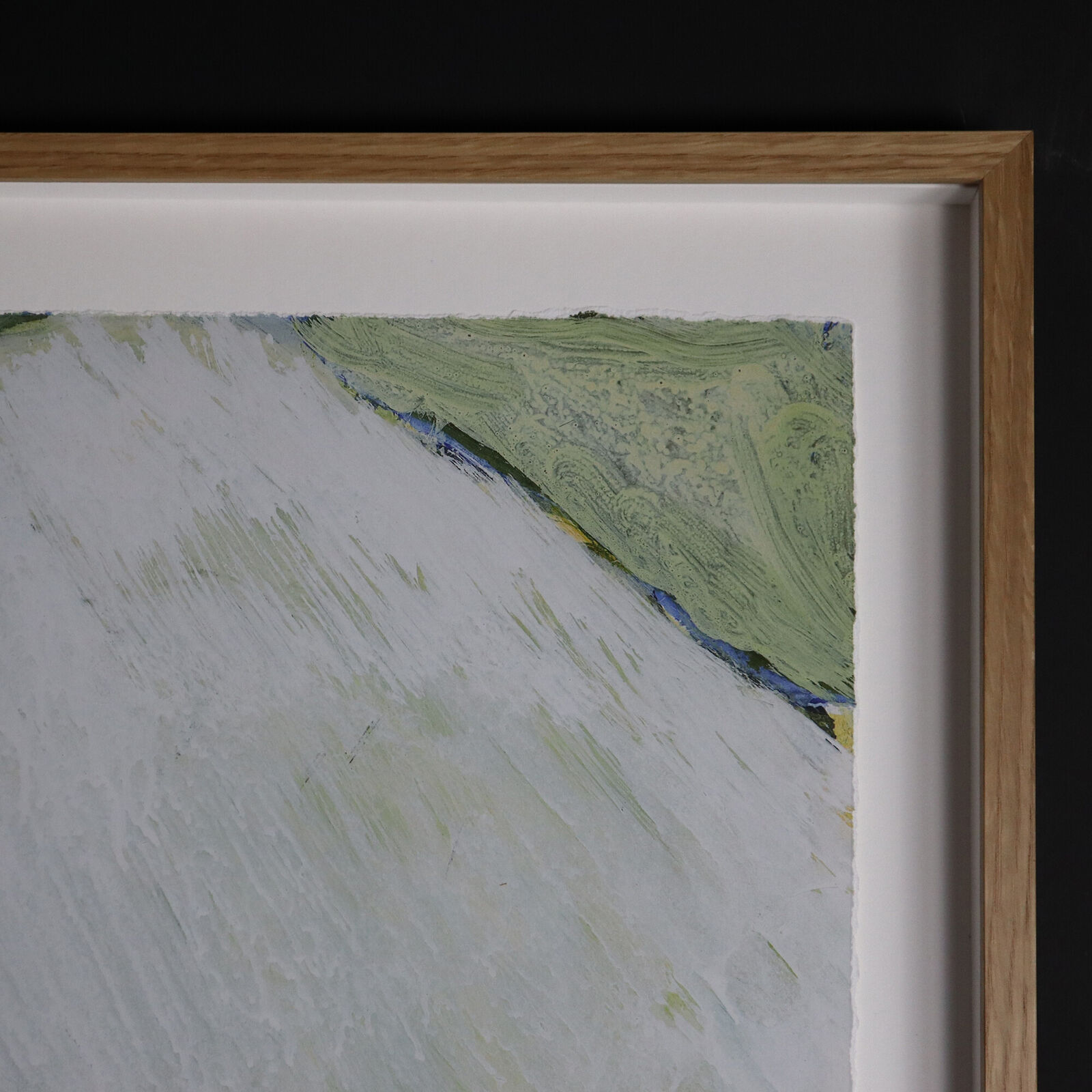 A group of paintings hanging on a wall in a room.