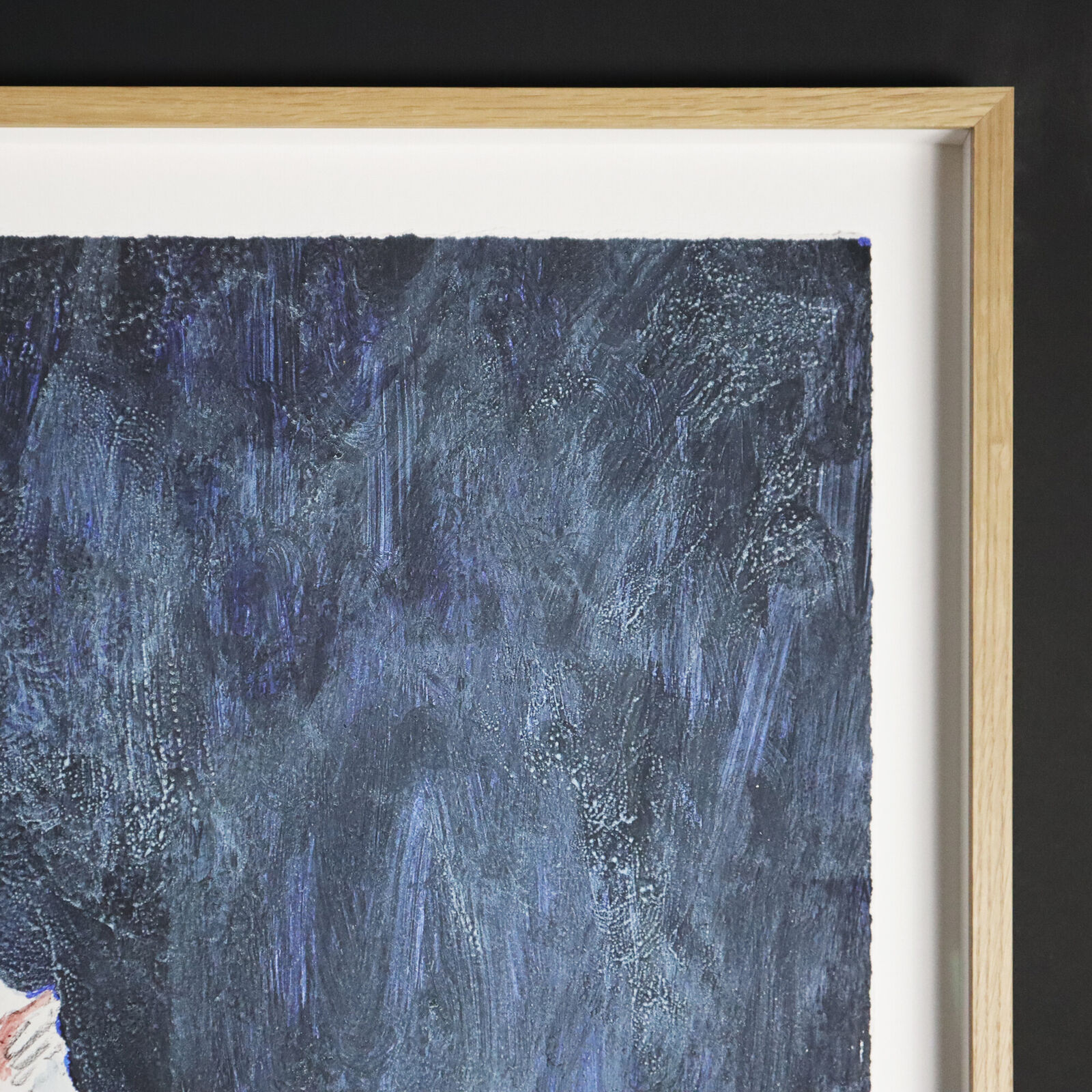 A group of paintings hanging on a wall in a room.