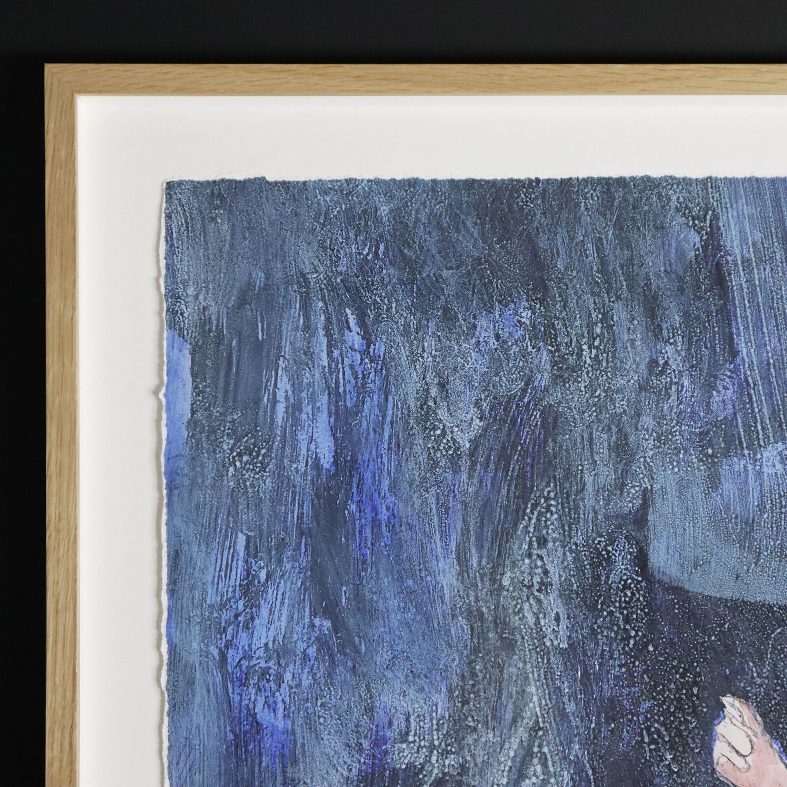 A group of paintings hanging on a wall in a room.