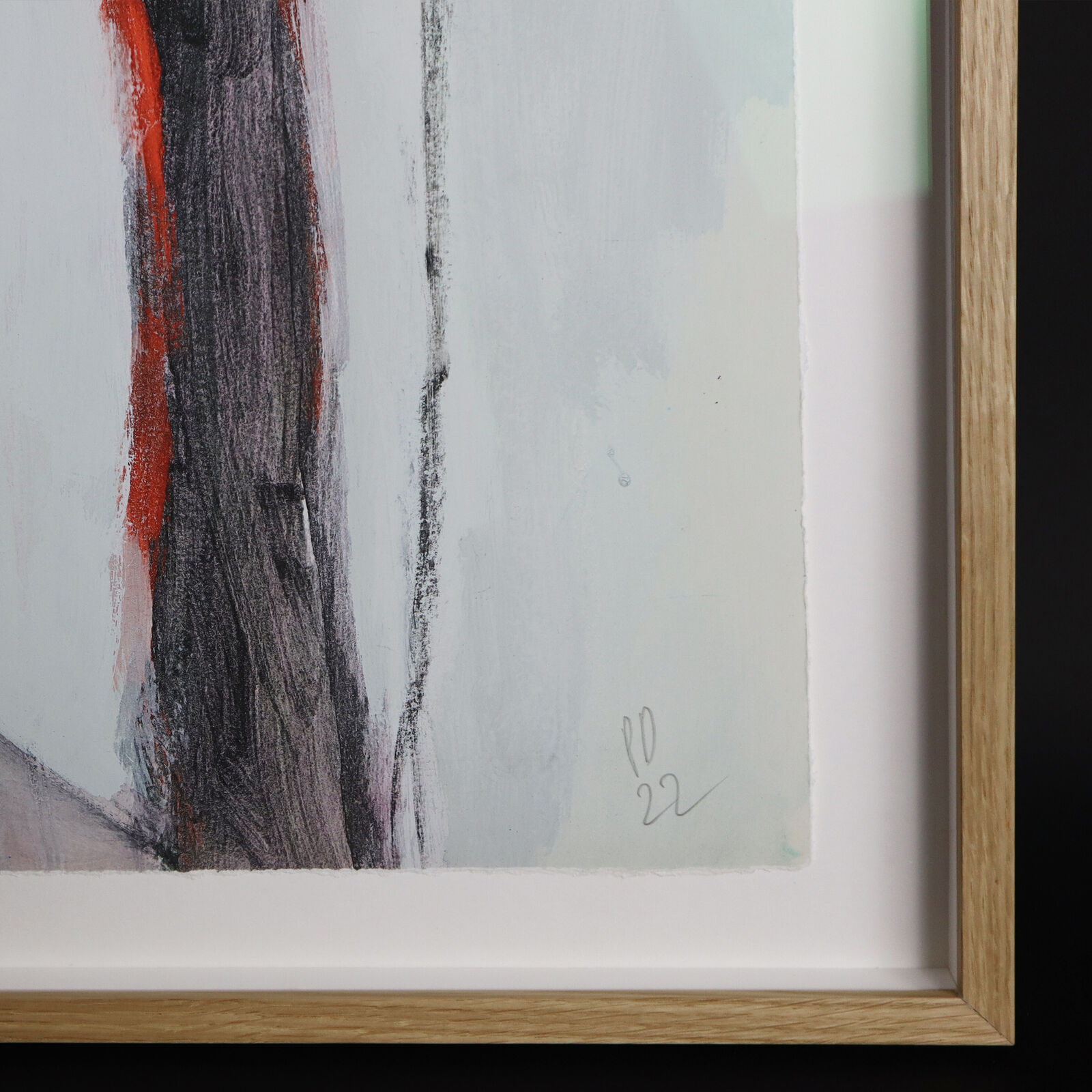 A group of paintings hanging on a wall in a room.