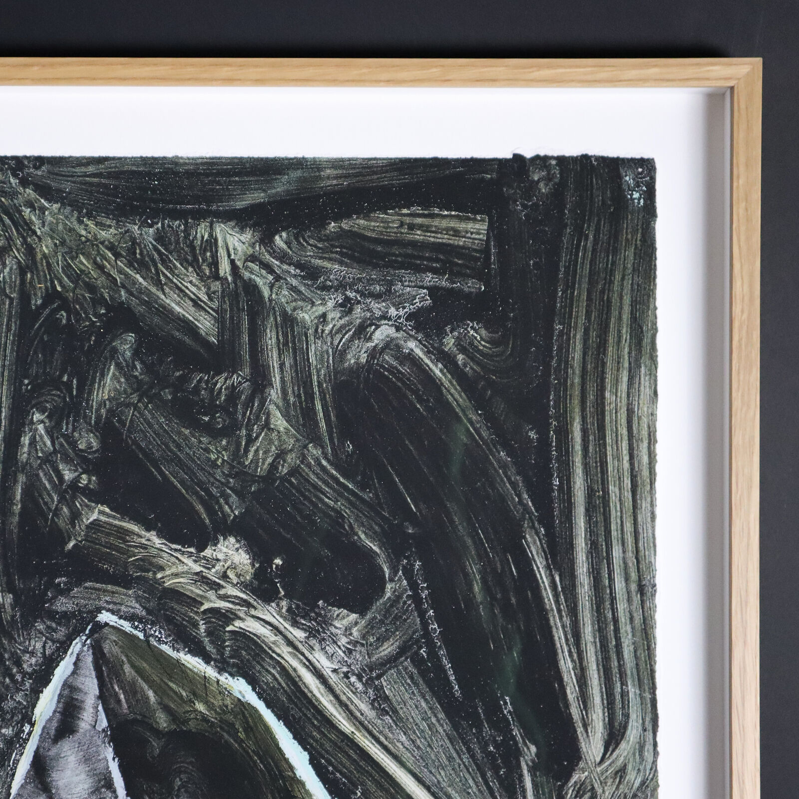 A group of paintings hanging on a wall in a room.