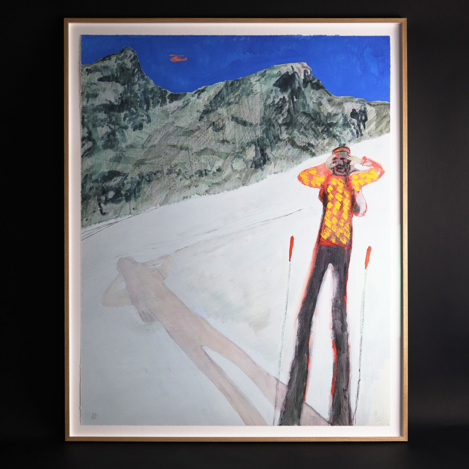 A group of paintings hanging on a wall in a room.