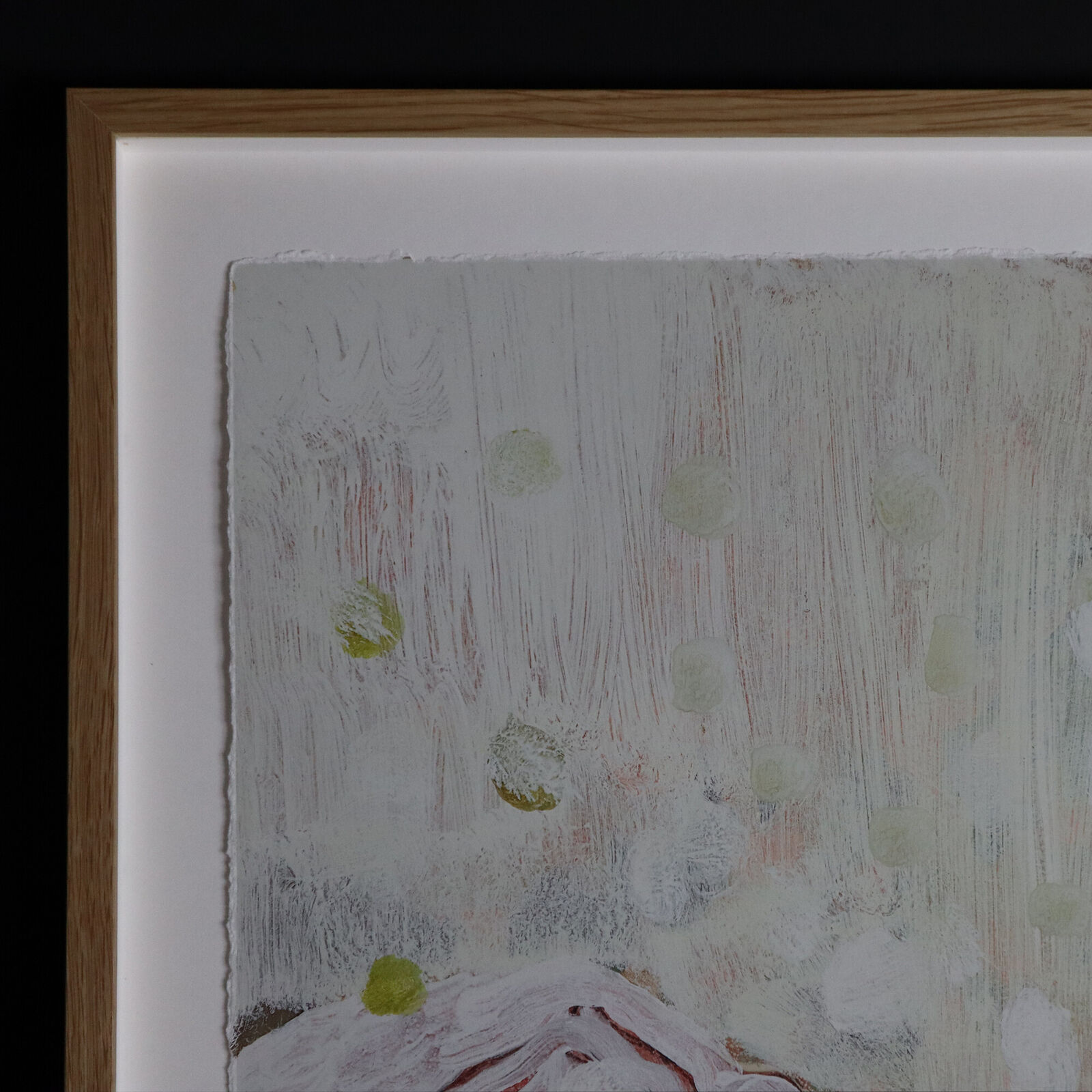 A group of paintings hanging on a wall in a room.