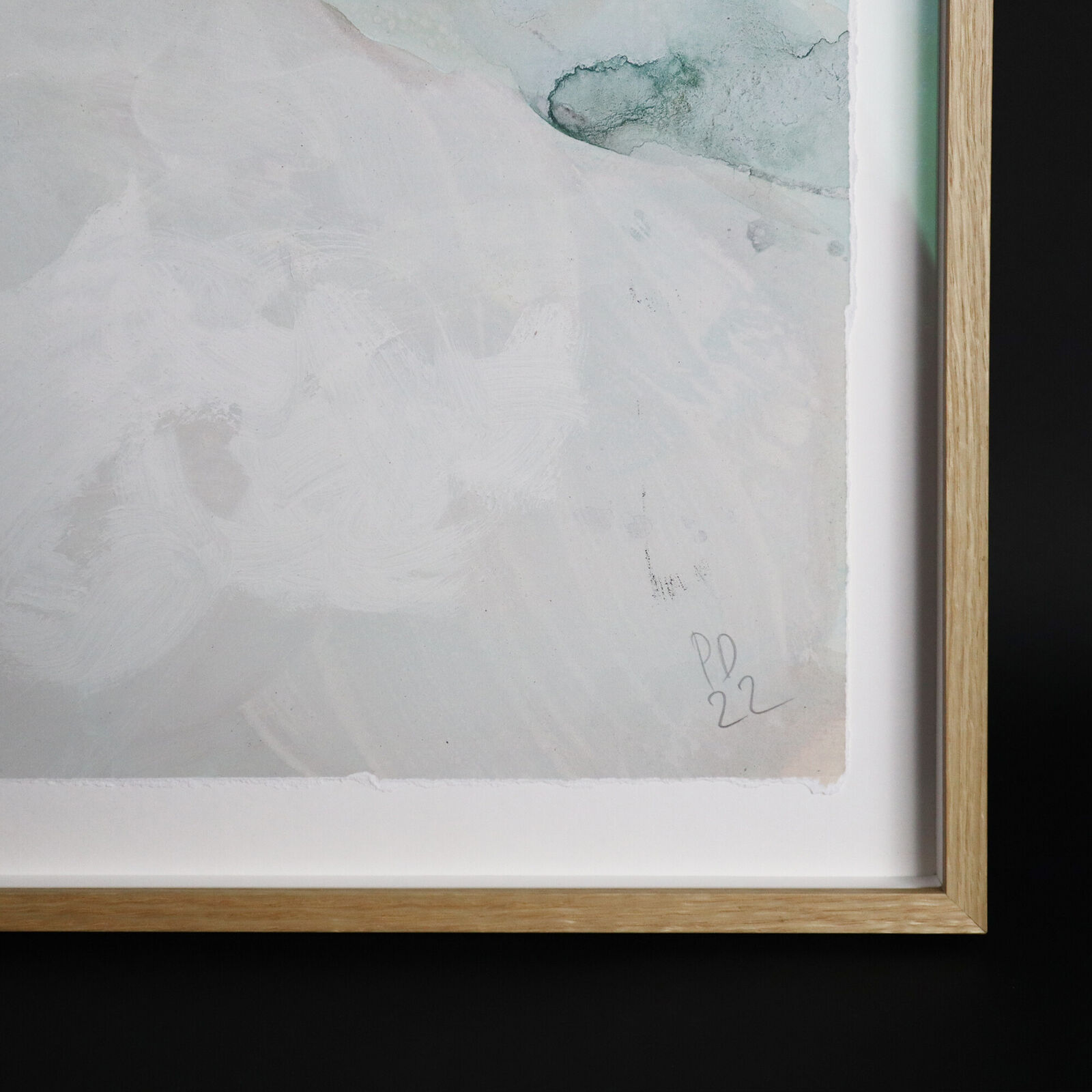 A group of paintings hanging on a wall in a room.